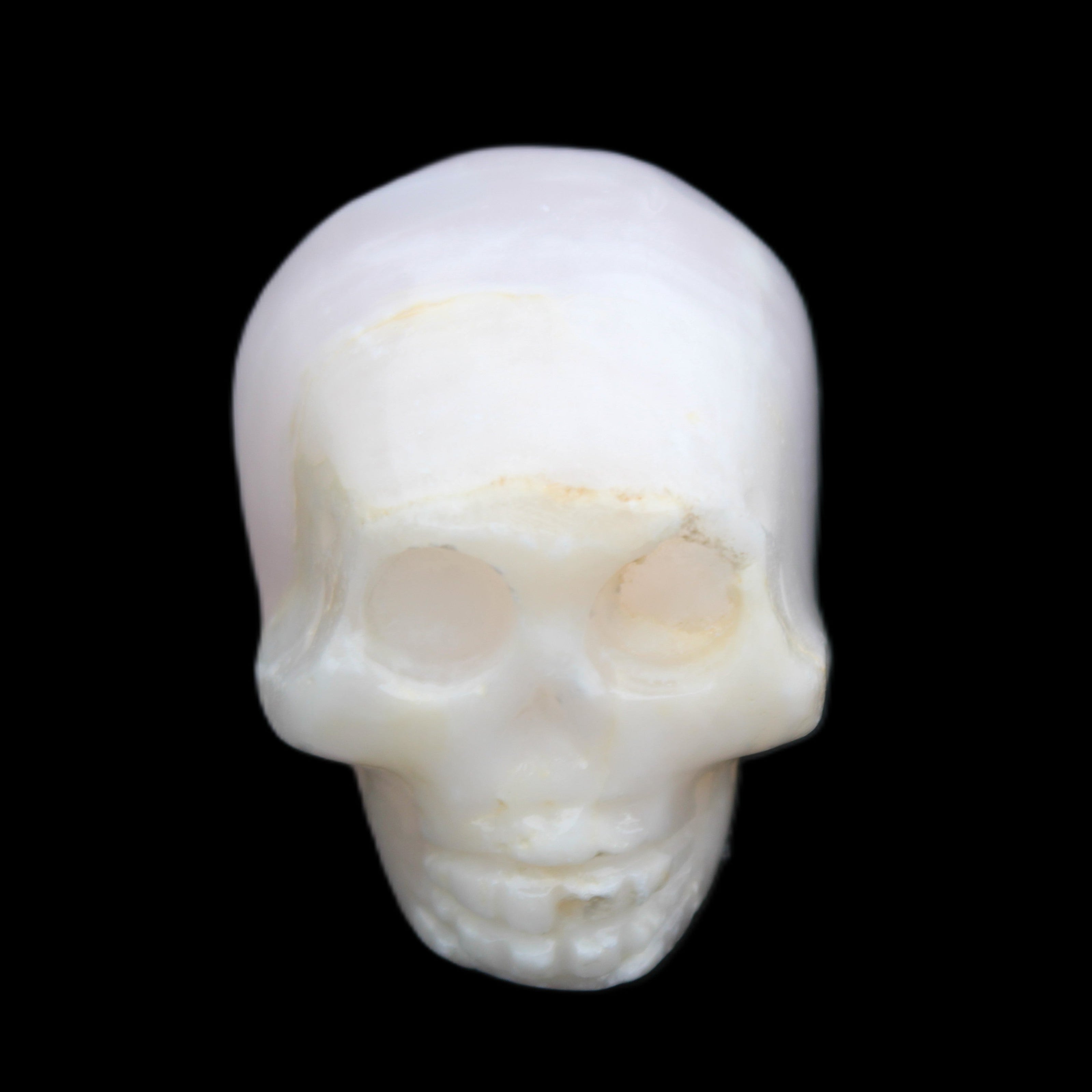 Mangano Calcite skull 31*46*36mm 83g in sunlight - Rocks and Things Store
