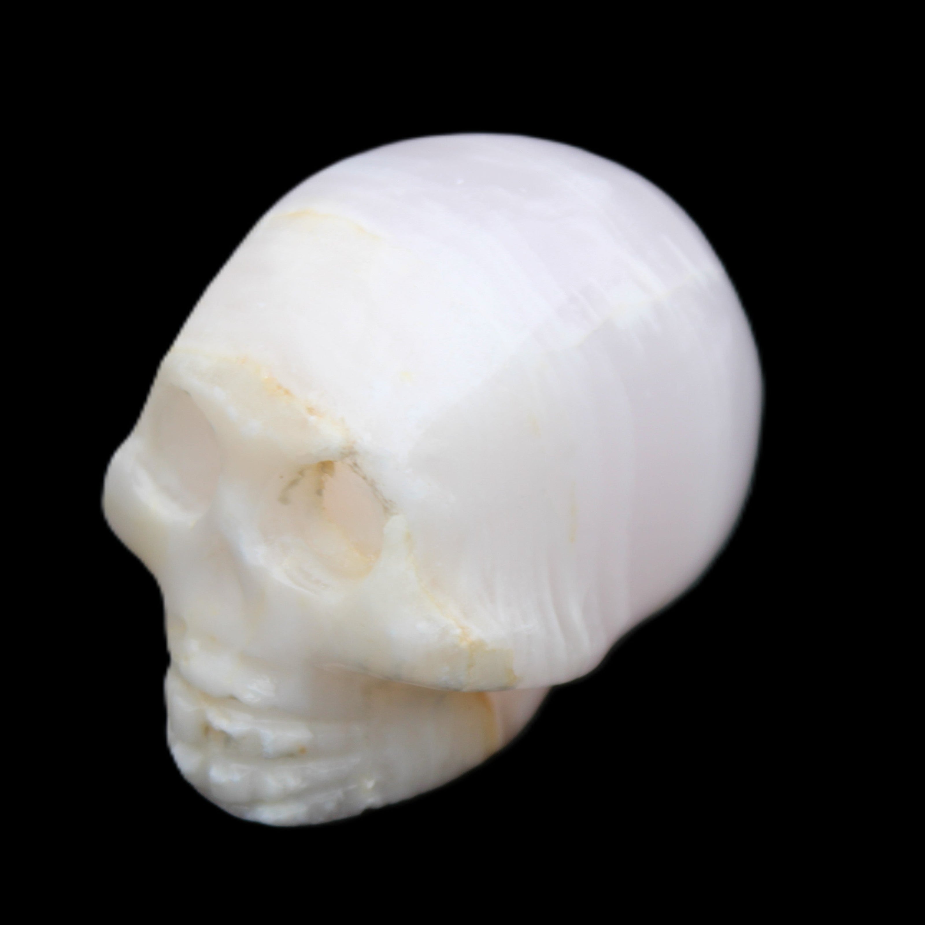 Mangano Calcite skull 31*46*36mm 83g in sunlight - Rocks and Things Store