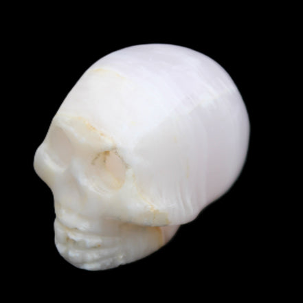 Mangano Calcite skull 31*46*36mm 83g in sunlight - Rocks and Things Store