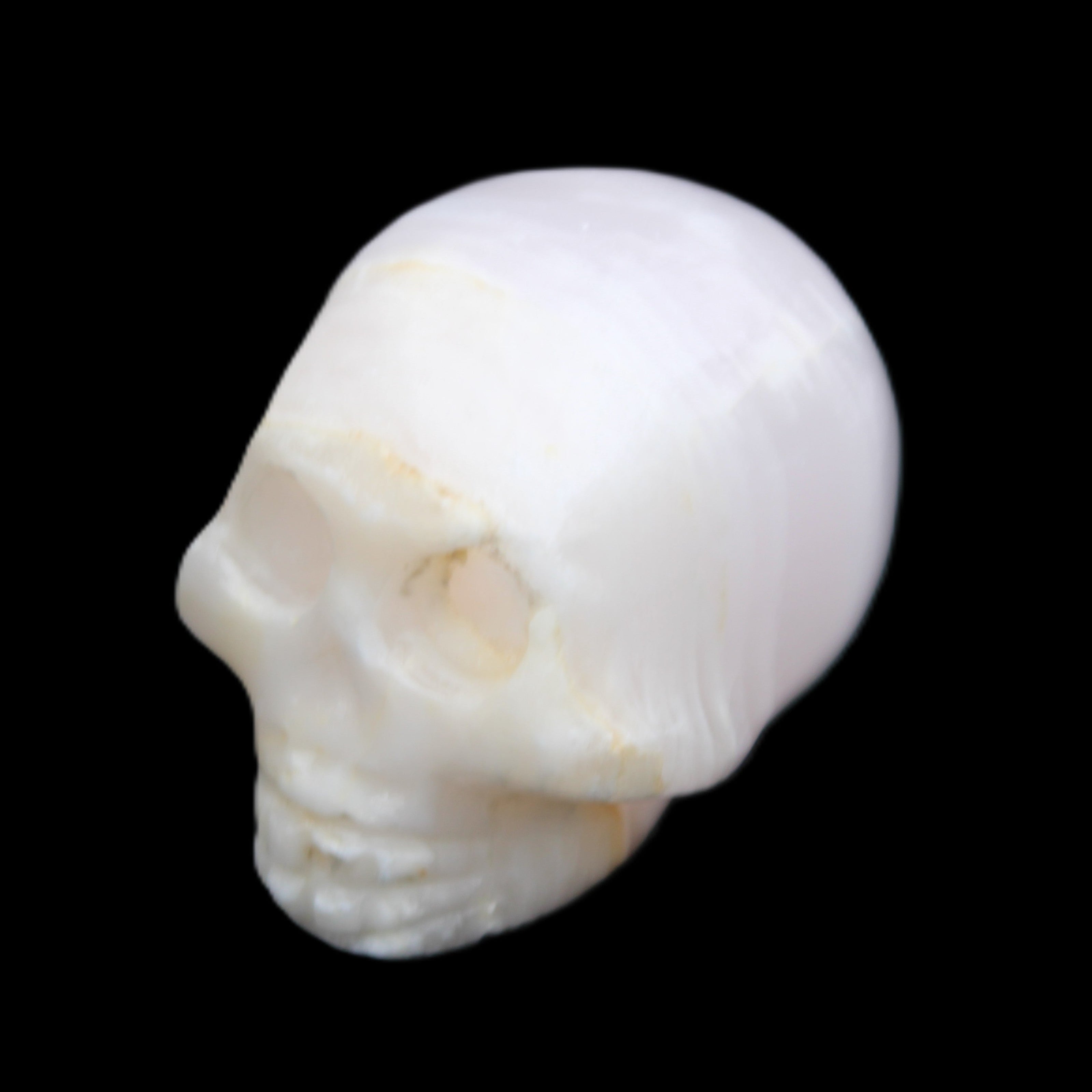 Mangano Calcite skull 31*46*36mm 83g in sunlight - Rocks and Things Store