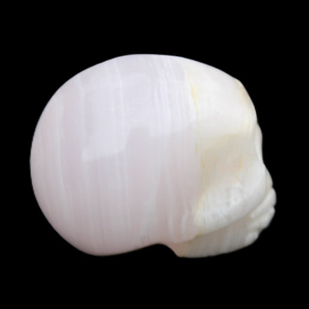 Mangano Calcite skull 31*46*36mm 83g in sunlight - Rocks and Things Store