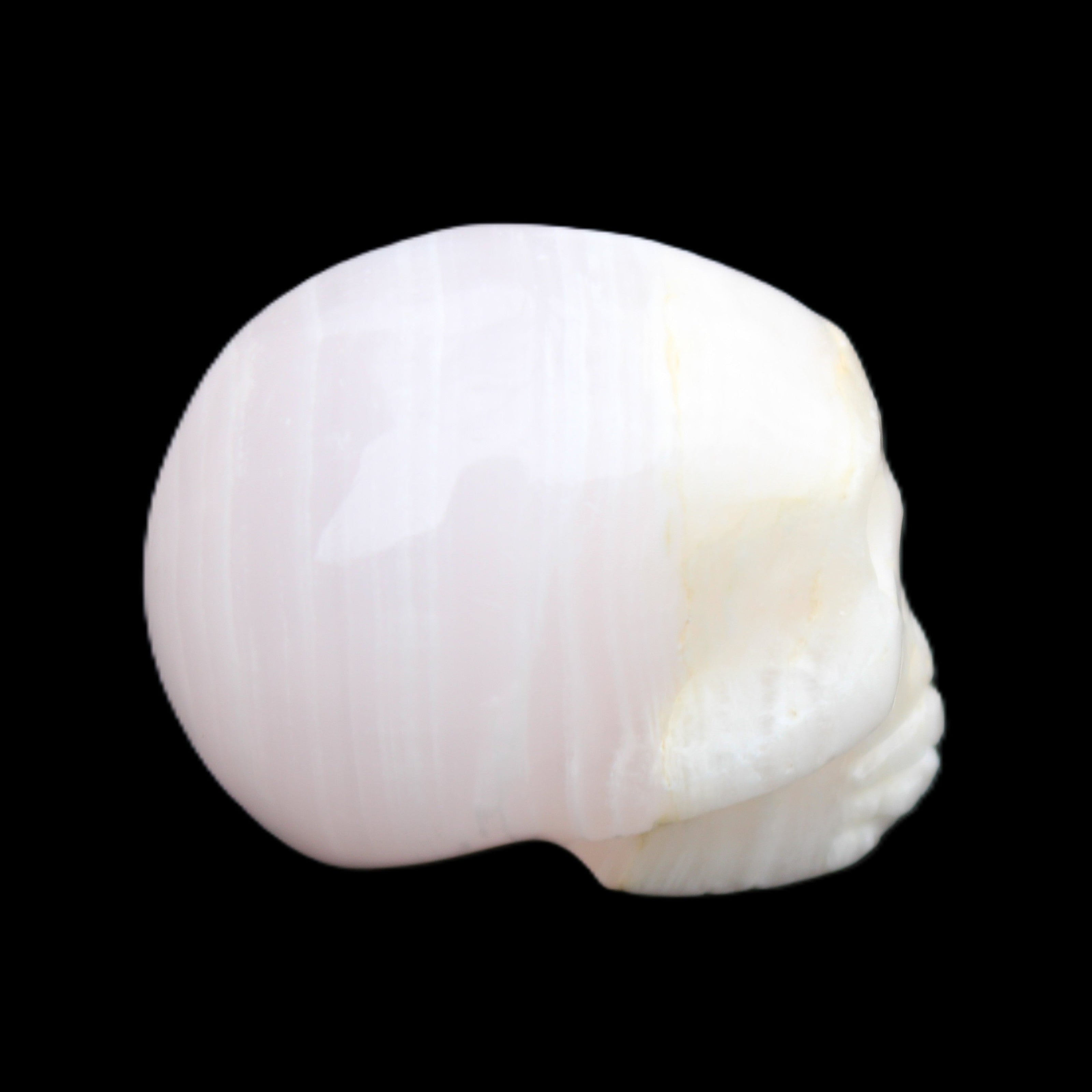 Mangano Calcite skull 31*46*36mm 83g in sunlight - Rocks and Things Store