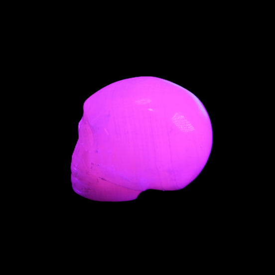 Mangano Calcite skull 30*45*38mm 78g in UV light - Rocks and Things Store