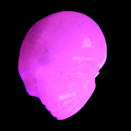 Mangano Calcite skull 30*45*38mm 78g in UV light - Rocks and Things Store
