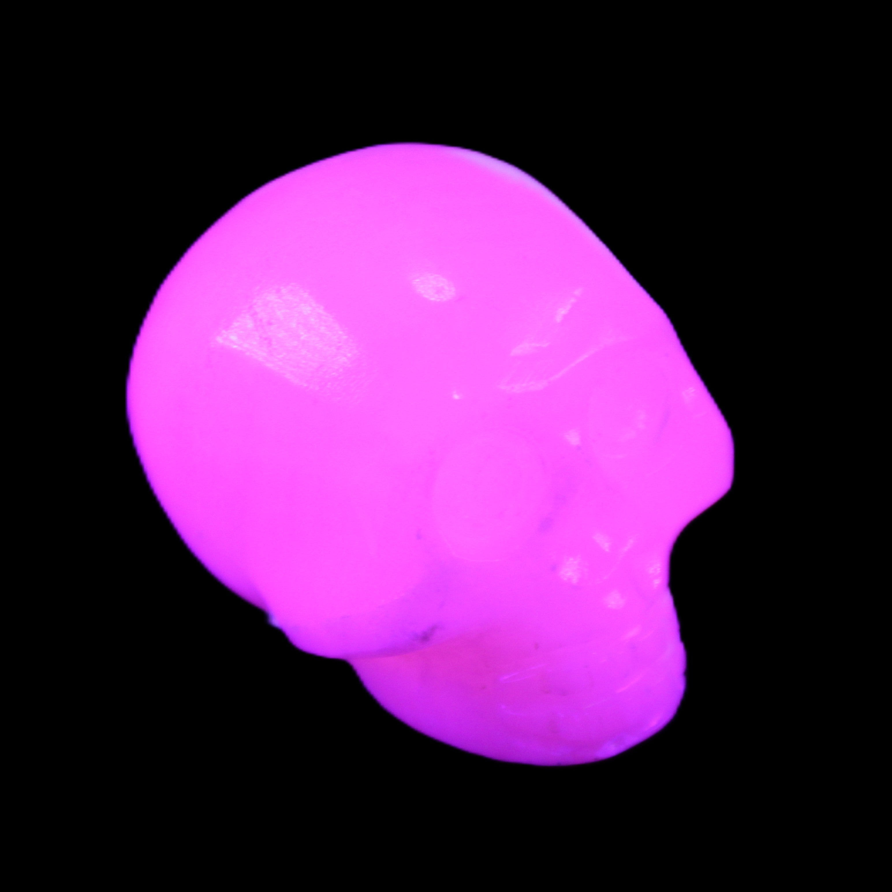 Mangano Calcite skull 30*45*38mm 78g in UV light - Rocks and Things Store