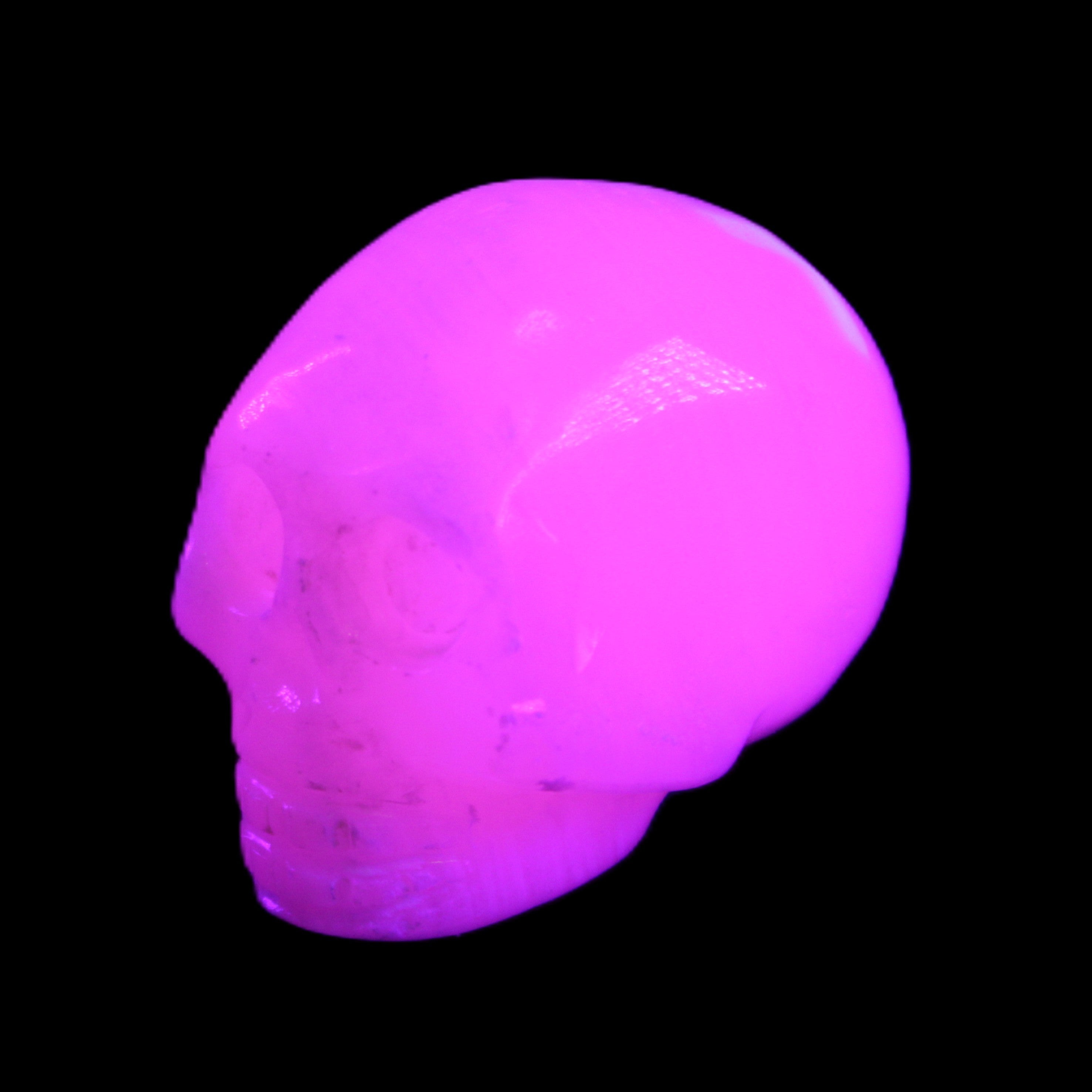 Mangano Calcite skull 30*45*38mm 78g in UV light - Rocks and Things Store