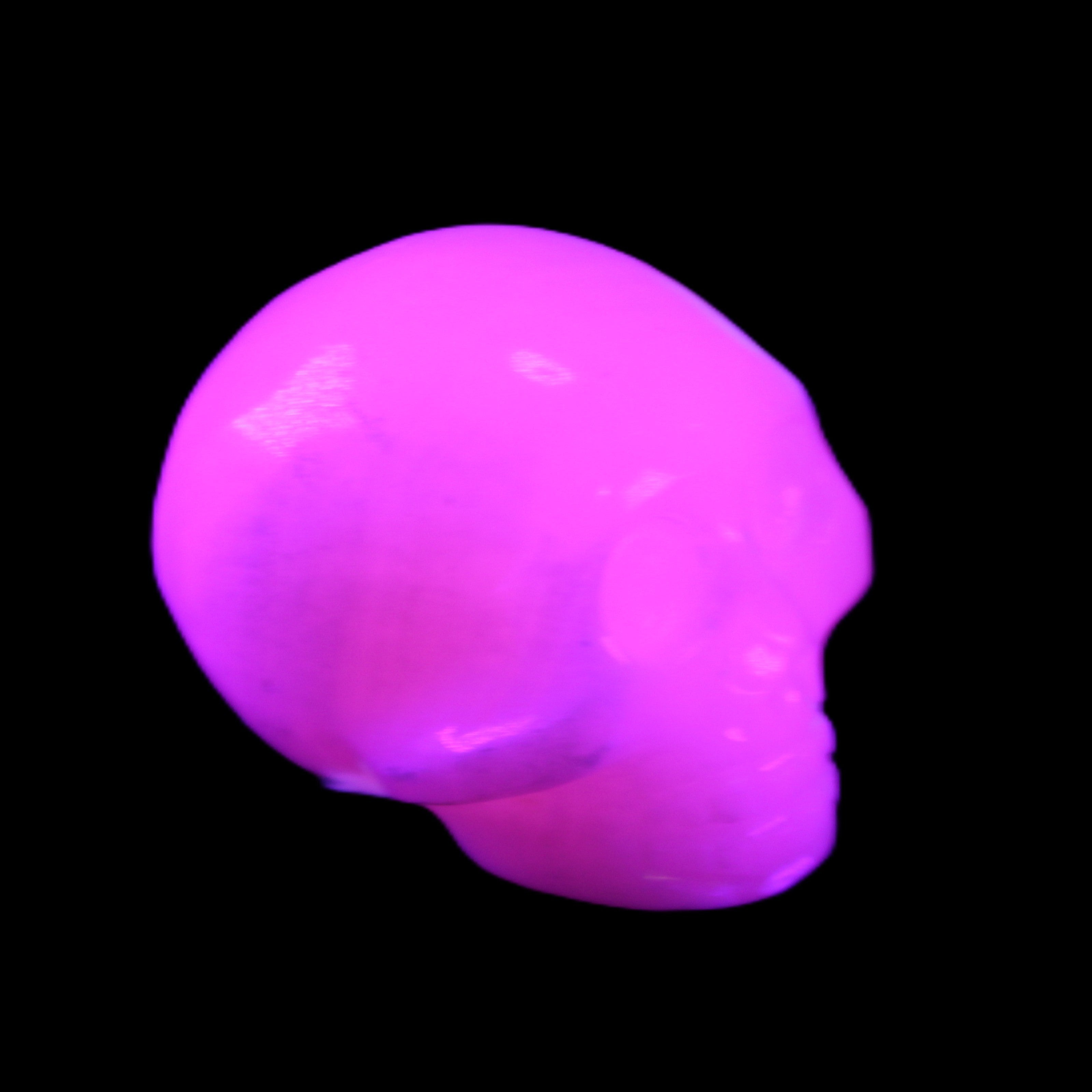 Mangano Calcite skull 30*45*38mm 78g in UV light - Rocks and Things Store