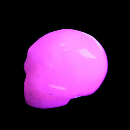 Mangano Calcite skull 30*45*38mm 78g in UV light - Rocks and Things Store