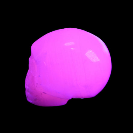 Mangano Calcite skull 30*45*38mm 78g in UV light - Rocks and Things Store