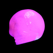 Mangano Calcite skull 30*45*38mm 78g in UV light - Rocks and Things Store