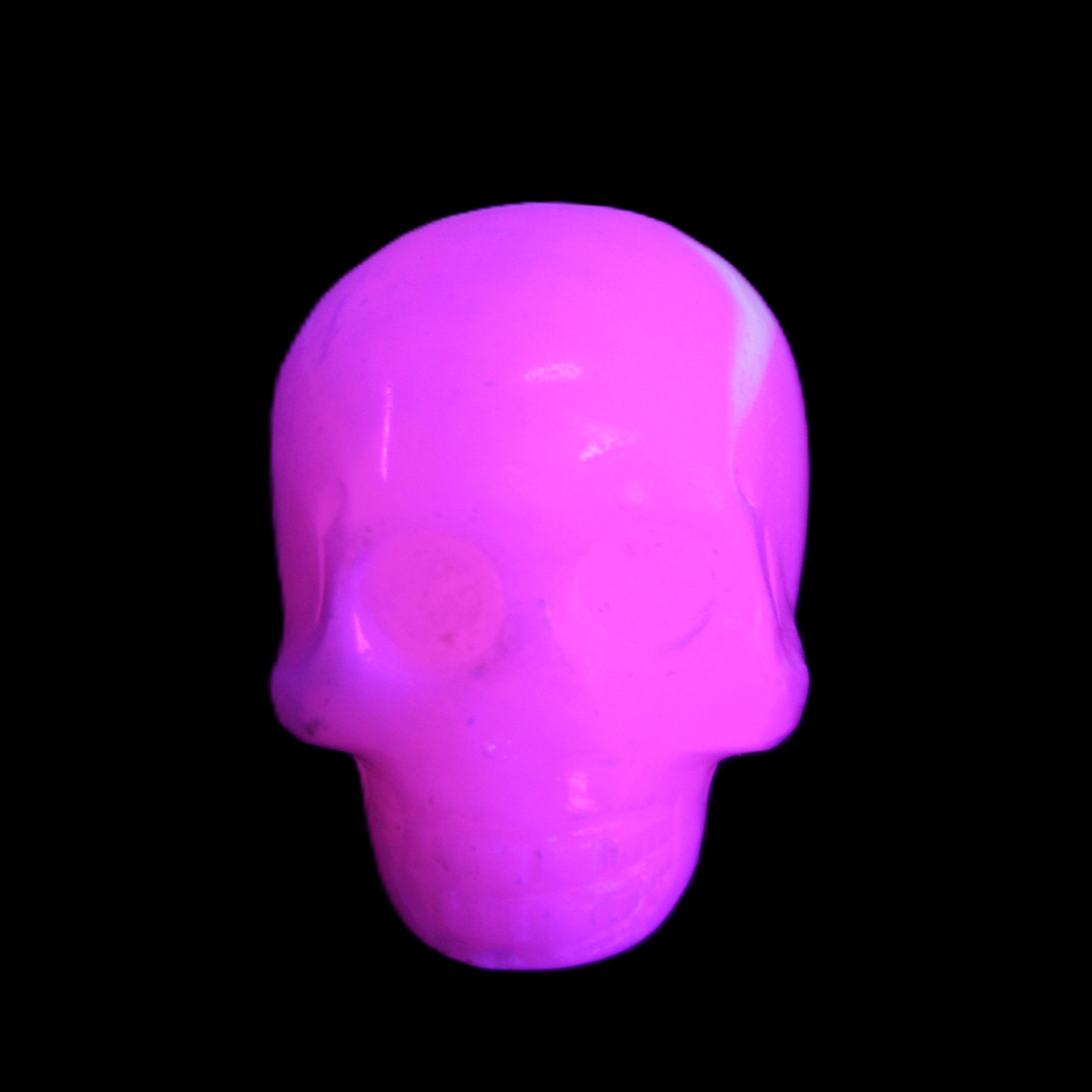 Mangano Calcite skull 30*45*38mm 78g in UV light - Rocks and Things Store