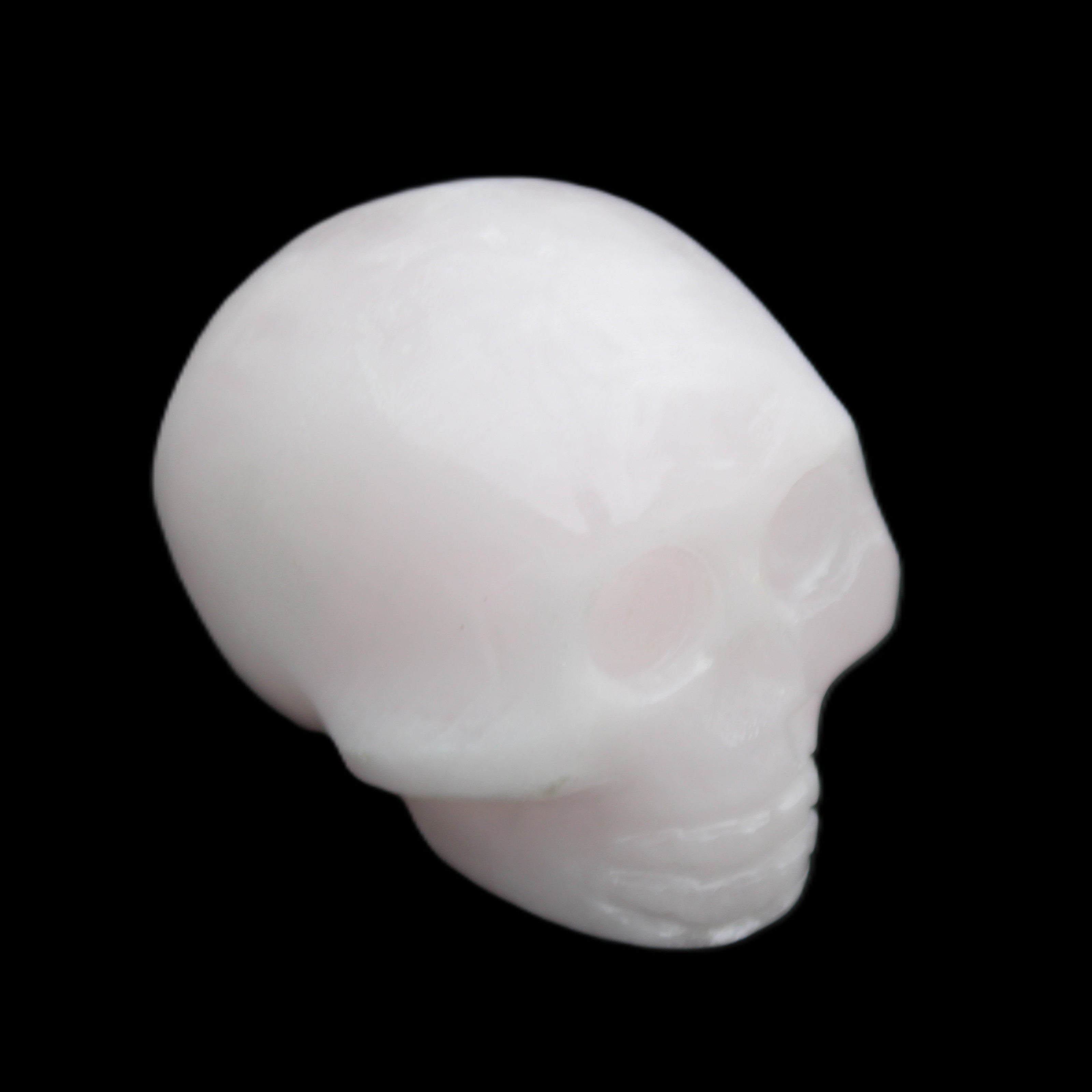 Mangano Calcite skull 30*45*38mm 78g in sunlight - Rocks and Things Store