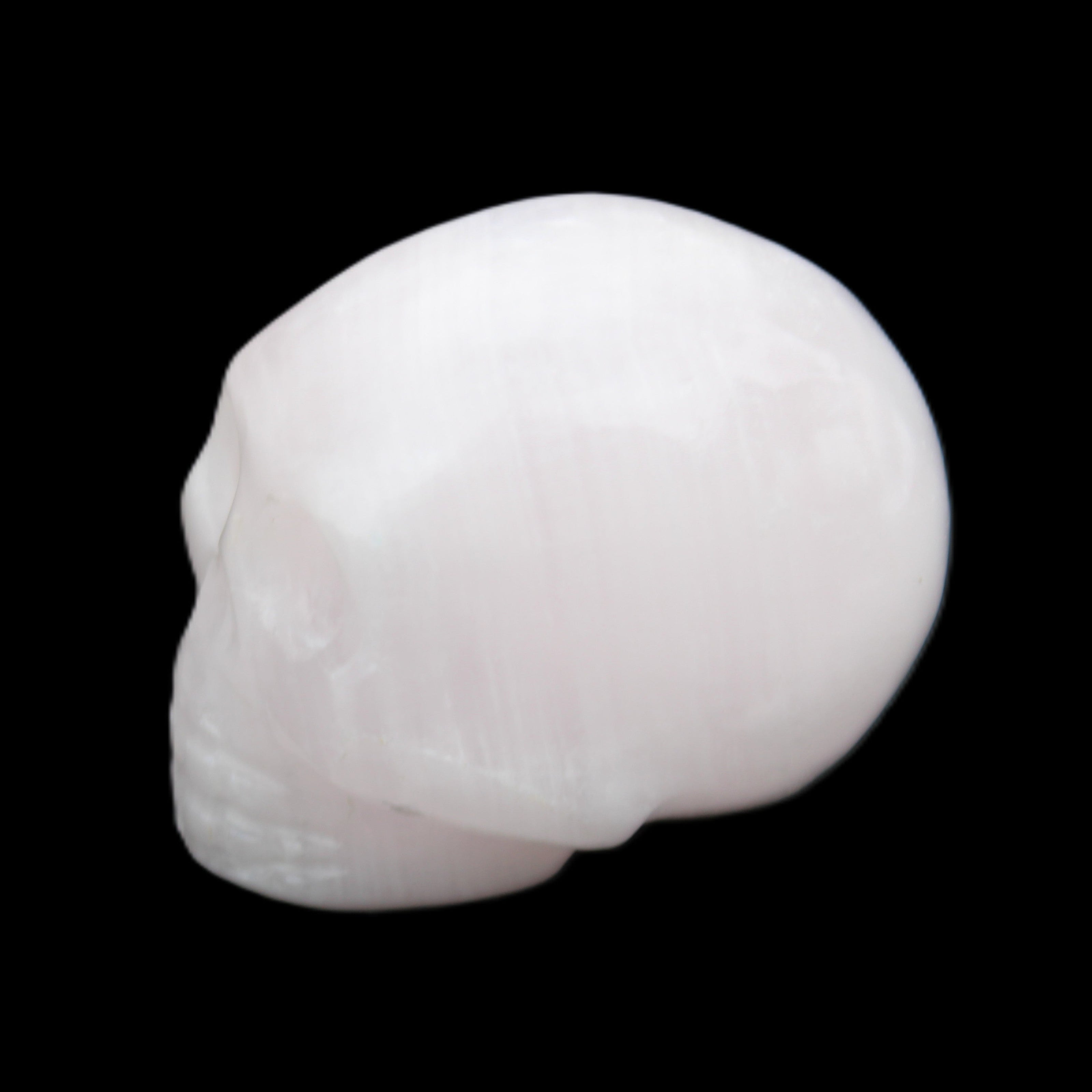 Mangano Calcite skull 30*45*38mm 78g in sunlight - Rocks and Things Store