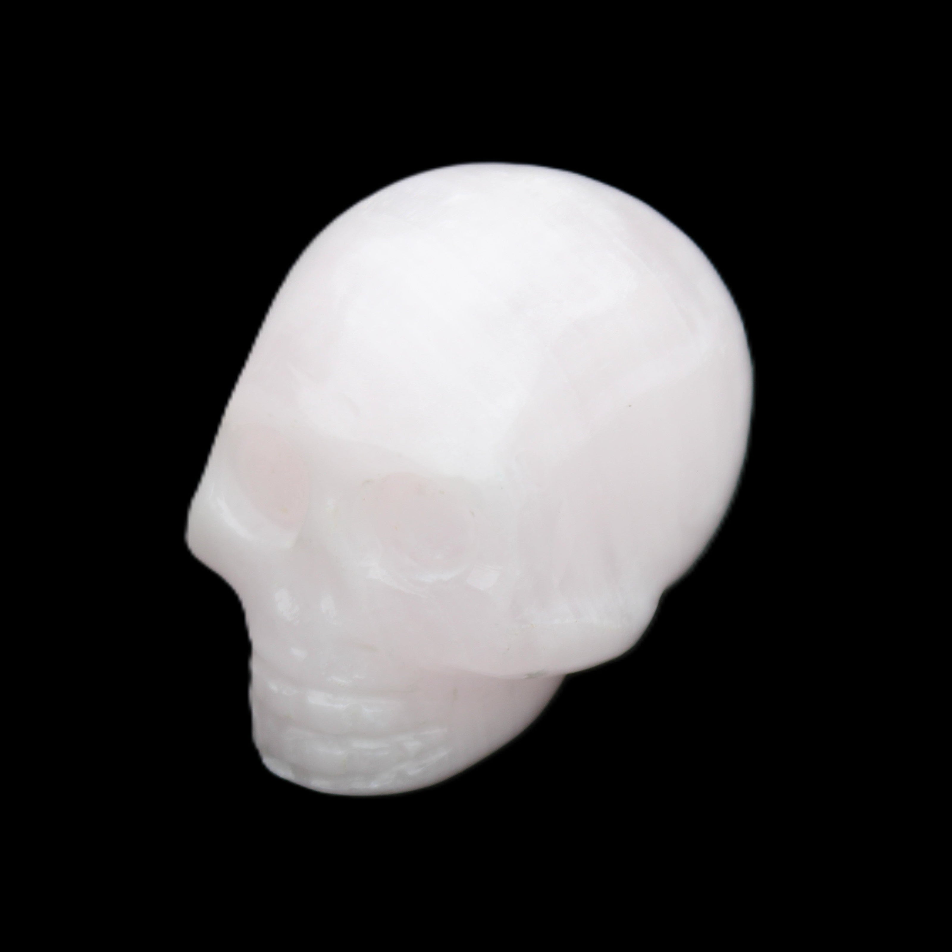 Mangano Calcite skull 30*45*38mm 78g in sunlight - Rocks and Things Store