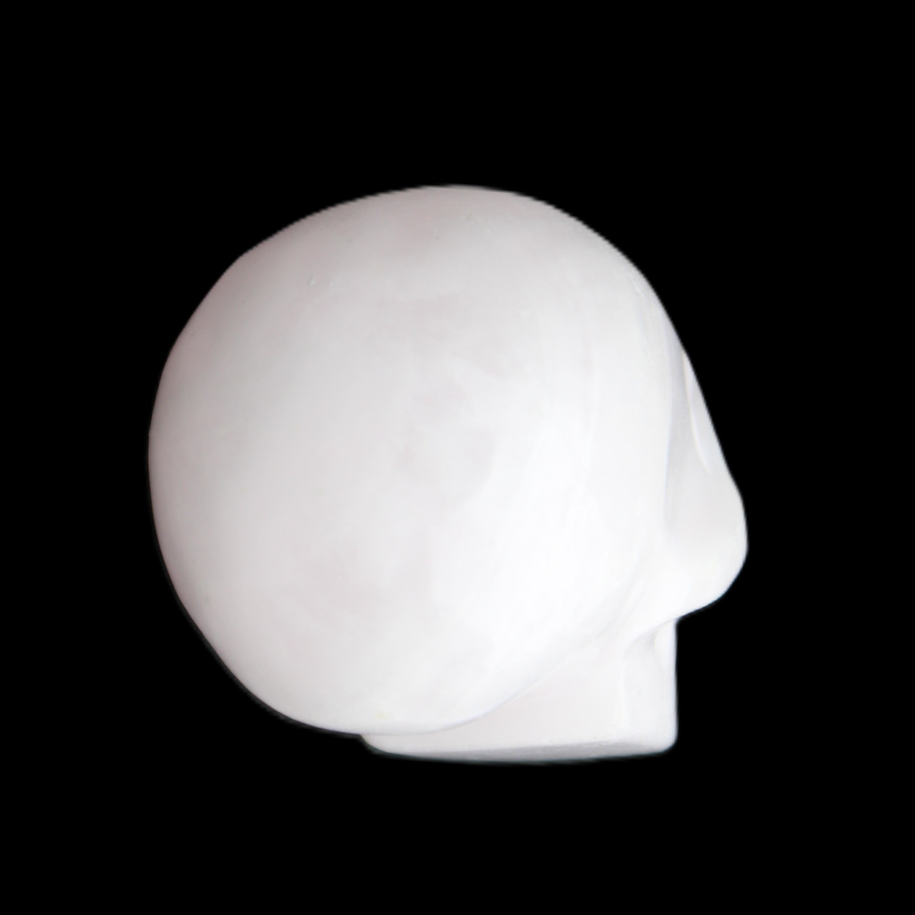 Mangano Calcite skull 30*45*38mm 78g in sunlight - Rocks and Things Store