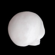 Mangano Calcite skull 30*45*38mm 78g in sunlight - Rocks and Things Store