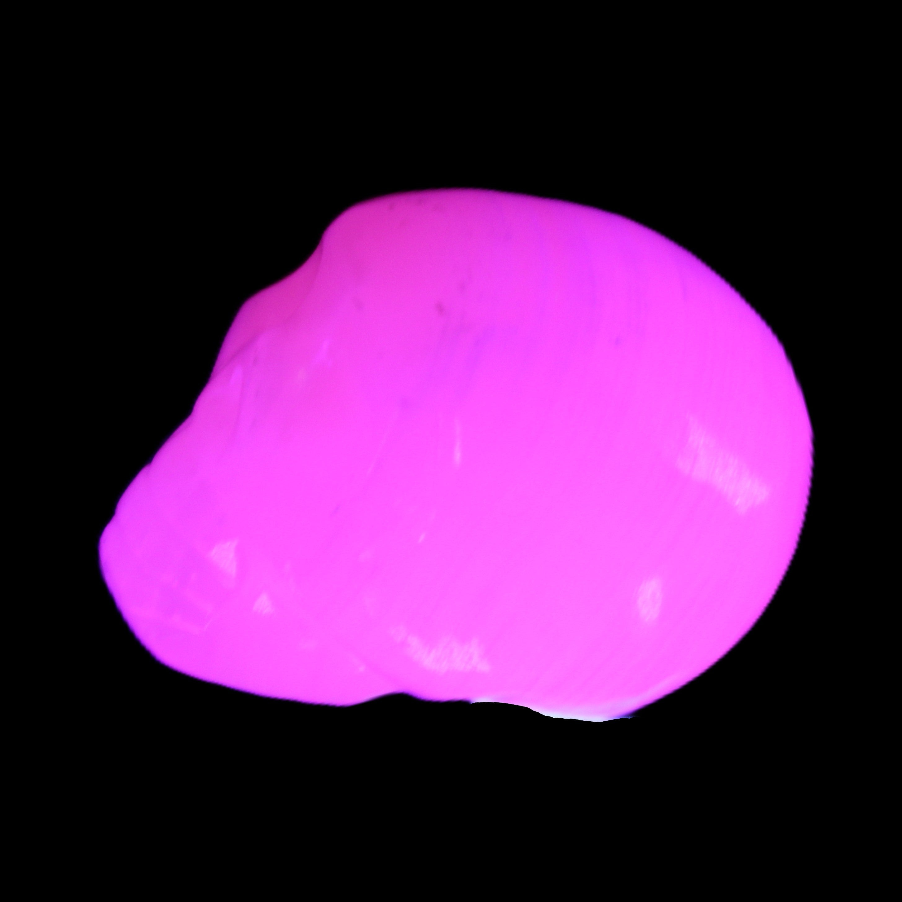 Mangano Calcite skull 30*42*35mm 83g in UV light - Rocks and Things Store
