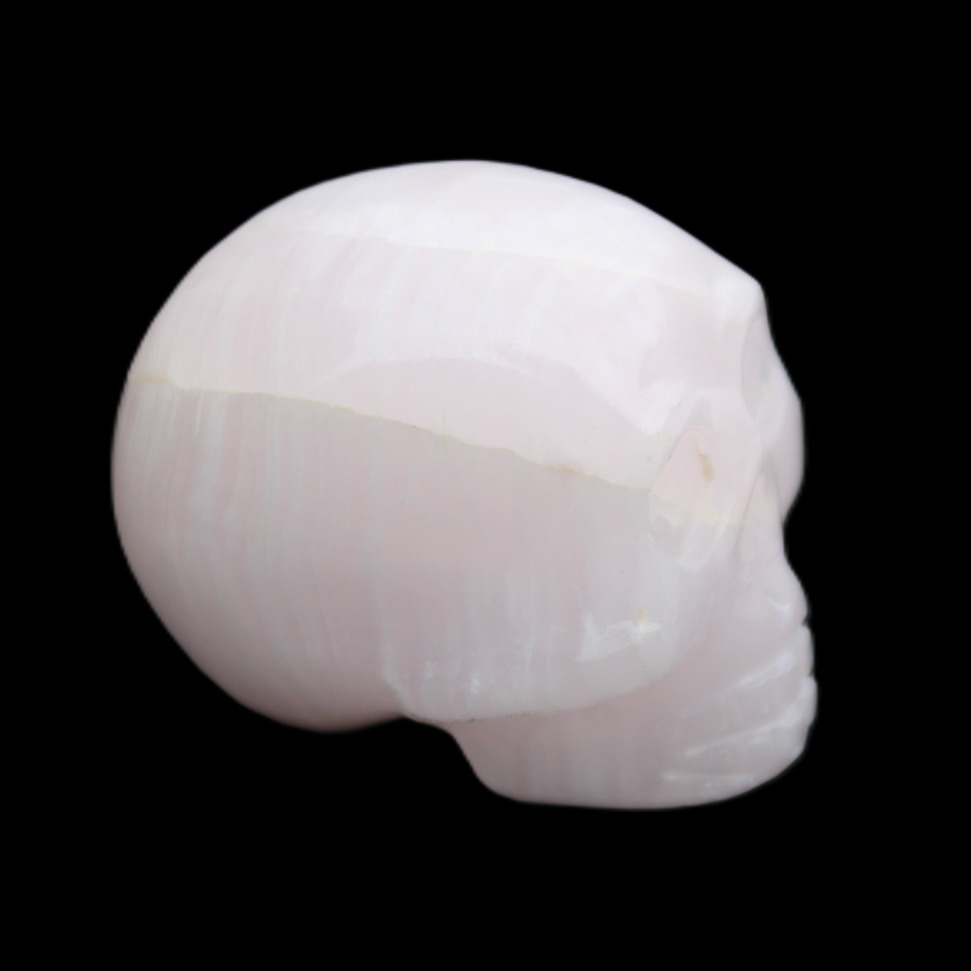 Mangano Calcite skull 30*42*35mm 83g in sunlight - Rocks and Things Store