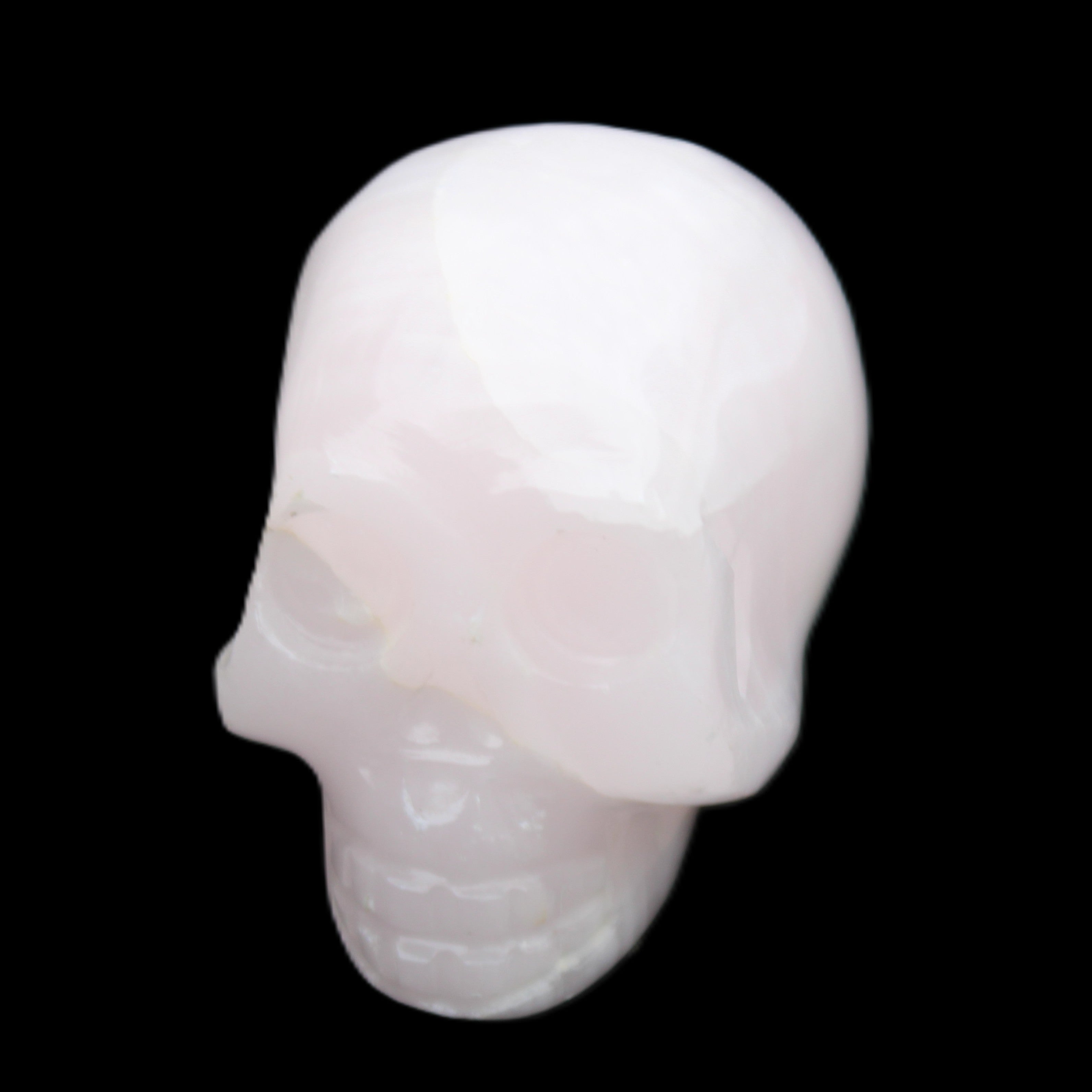 Mangano Calcite skull 30*42*35mm 83g in sunlight - Rocks and Things Store