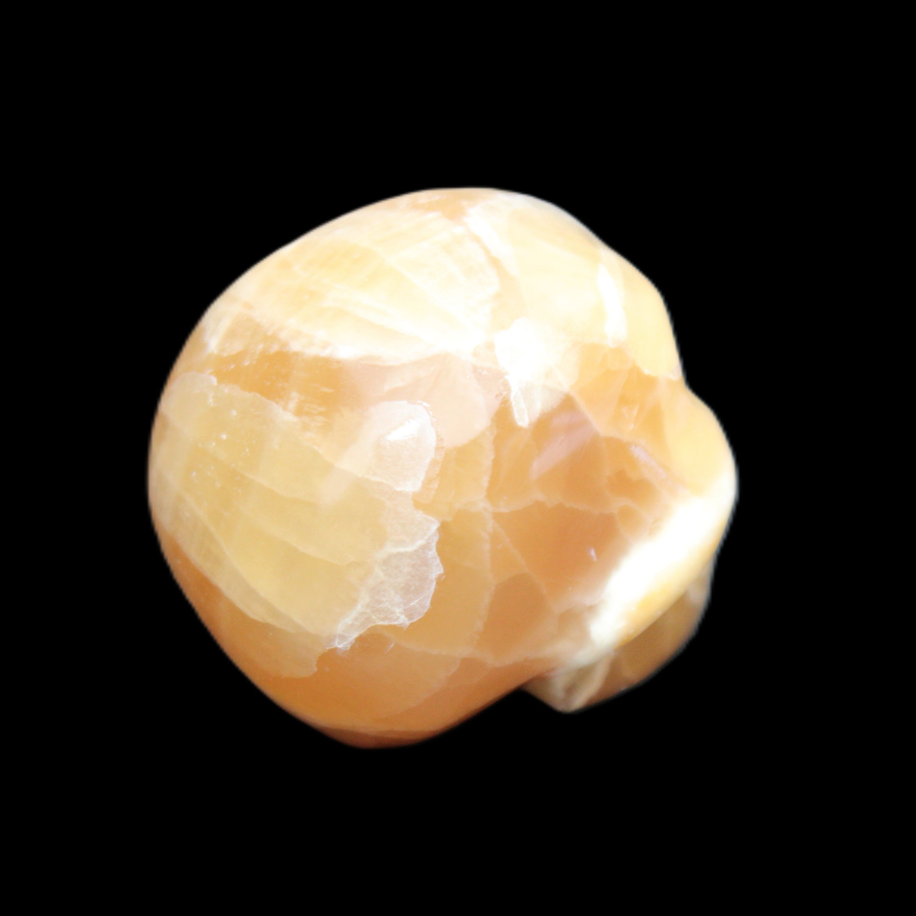 Honey Calcite skull from Pakistan 30*40*35mm 80g in sunlight - Rocks and Things Store