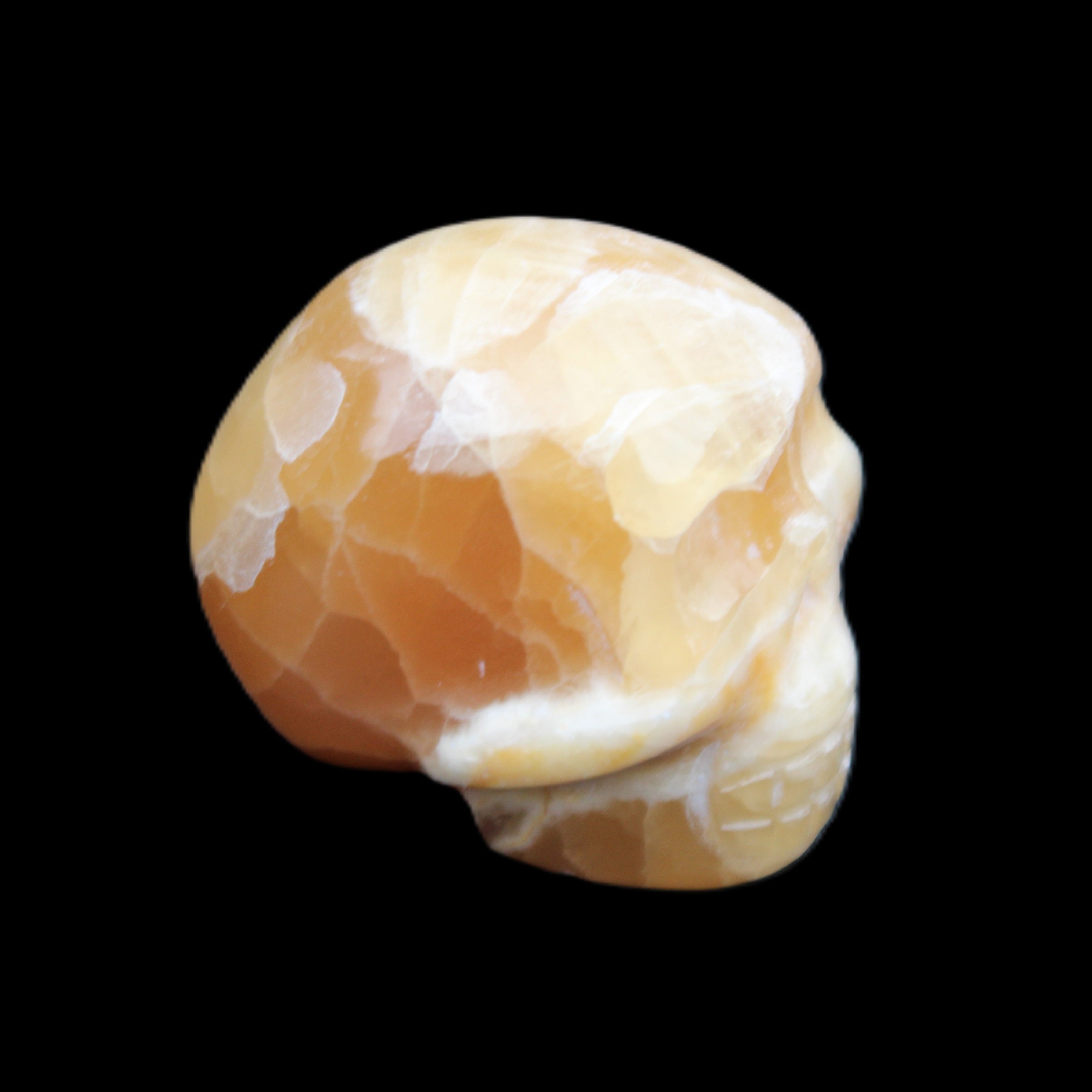 Honey Calcite skull from Pakistan 30*40*35mm 80g in sunlight - Rocks and Things Store