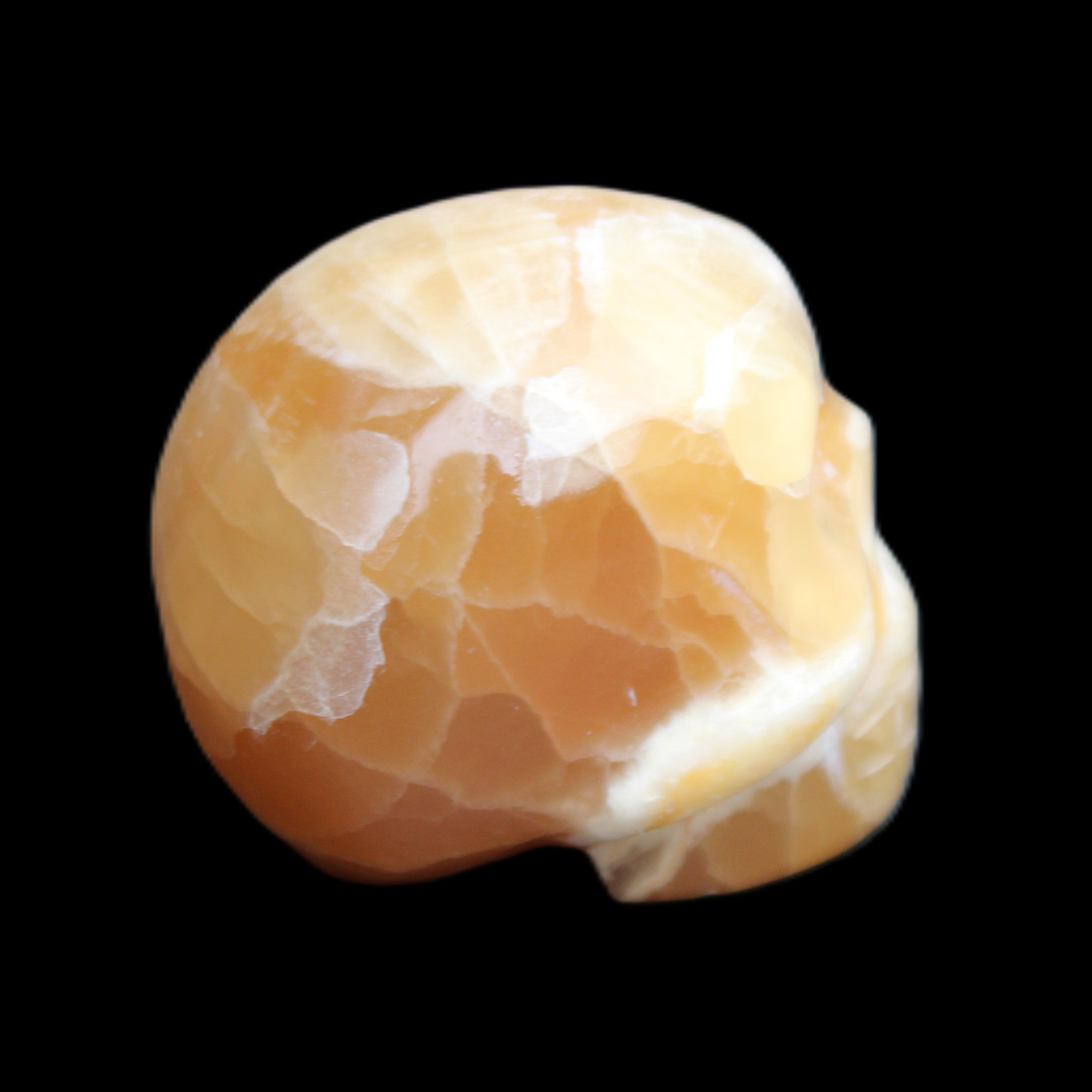 Honey Calcite skull from Pakistan 30*40*35mm 80g in sunlight - Rocks and Things Store