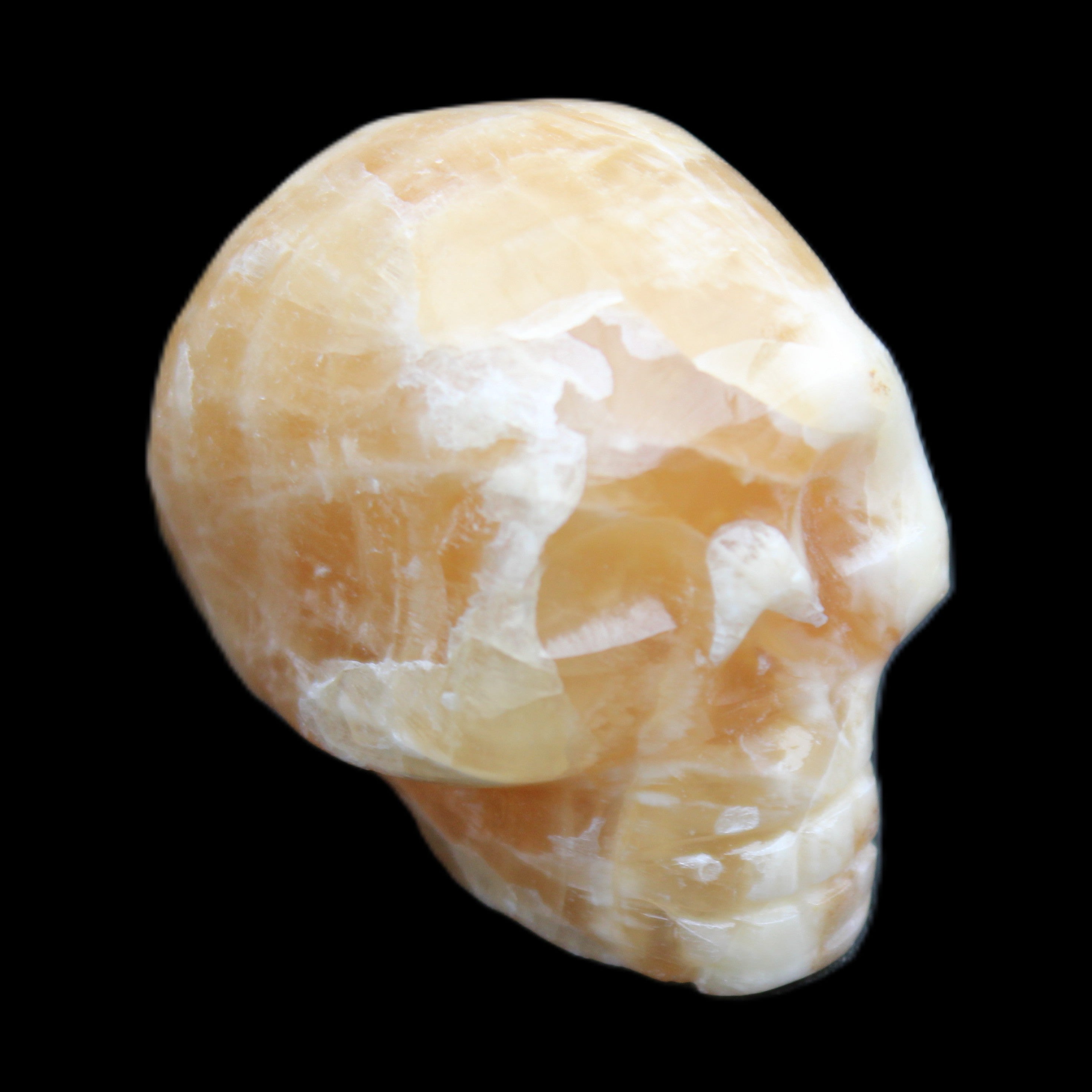 Honey Calcite skull from Pakistan 25*34*33mm 67g in sunlight - Rocks and Things Store