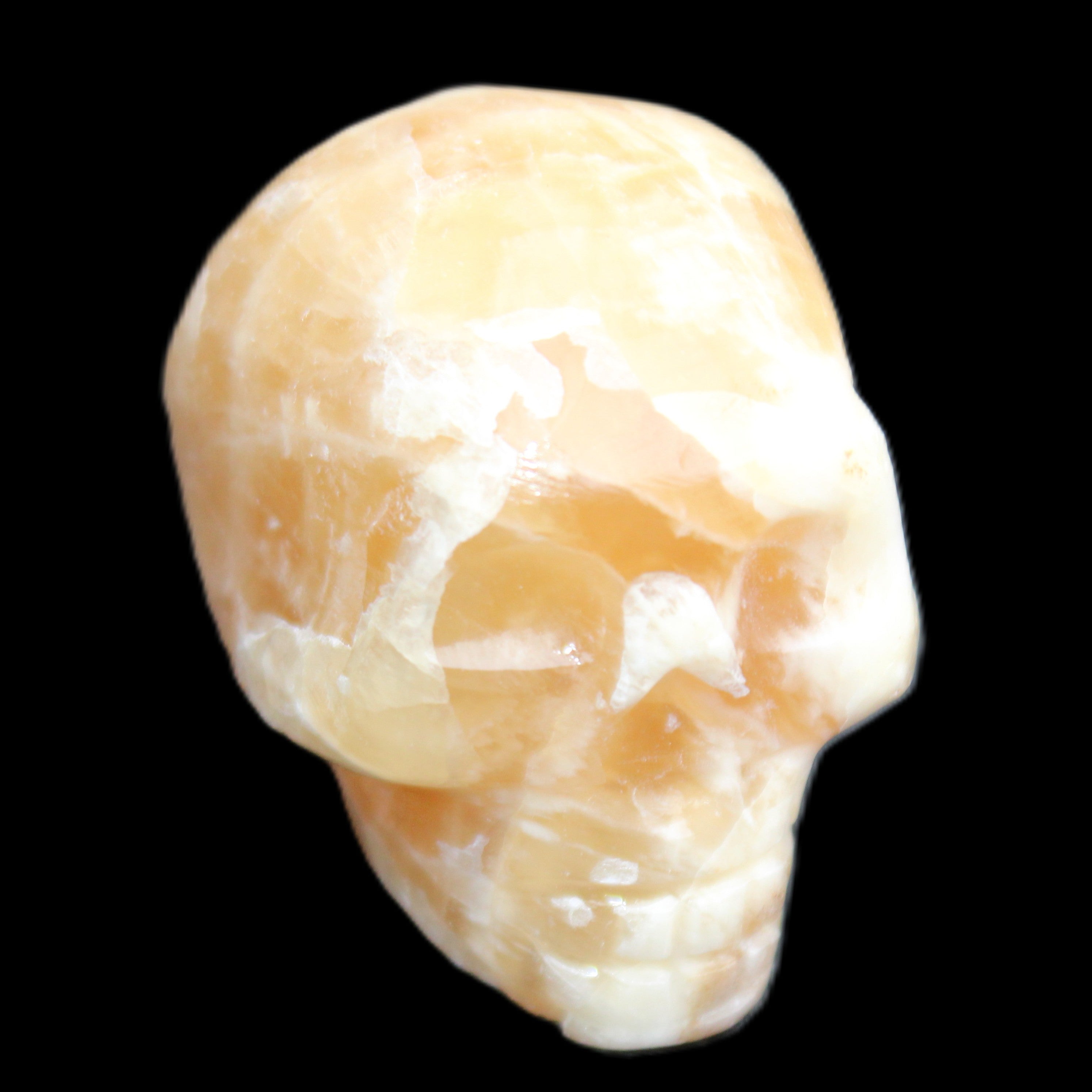 Honey Calcite skull from Pakistan 25*34*33mm 67g in sunlight - Rocks and Things Store