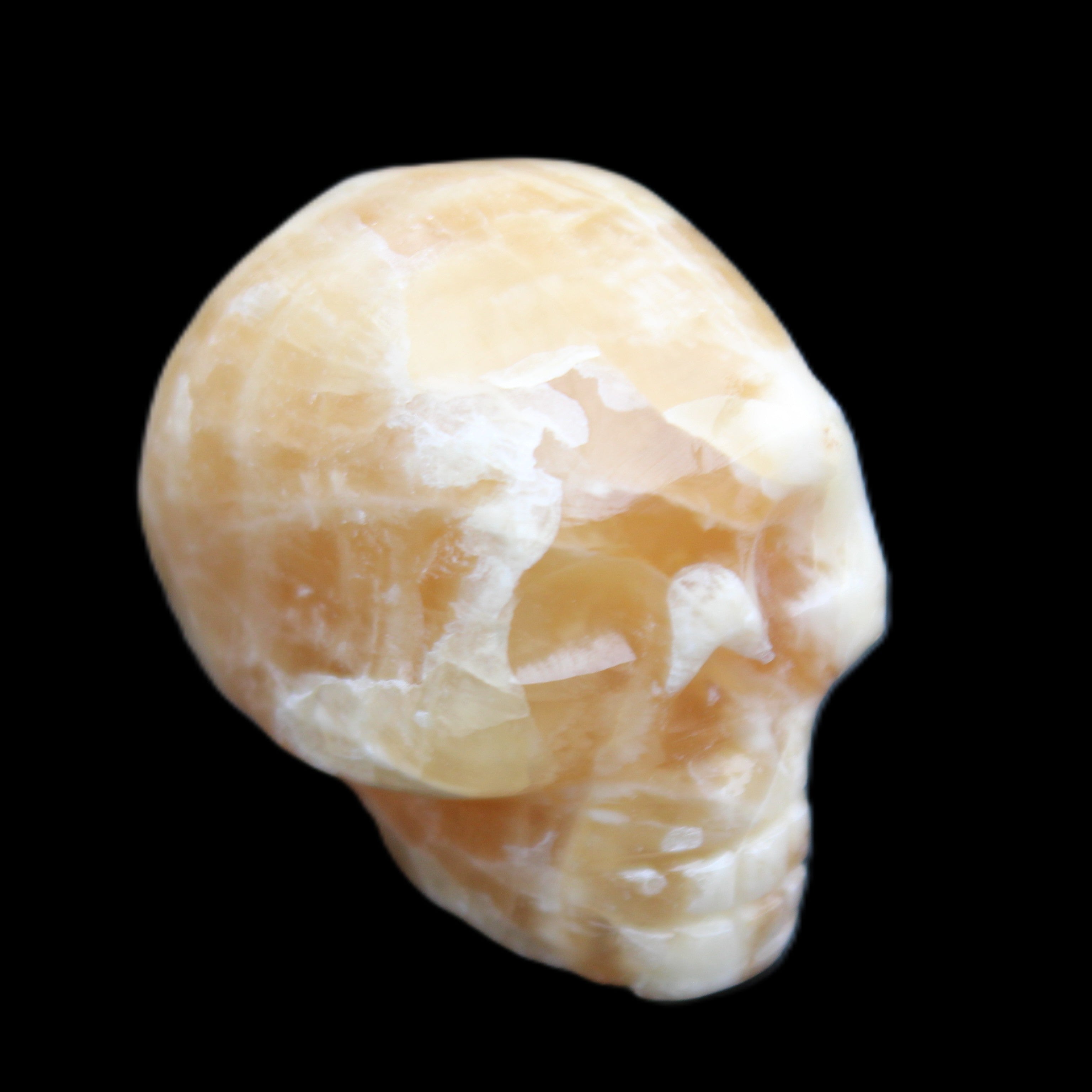 Honey Calcite skull from Pakistan 25*34*33mm 67g in sunlight - Rocks and Things Store