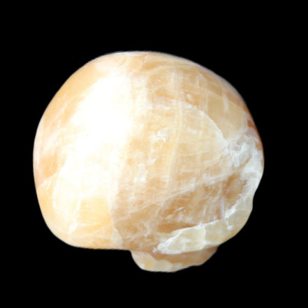 Honey Calcite skull from Pakistan 25*34*33mm 67g in sunlight - Rocks and Things Store