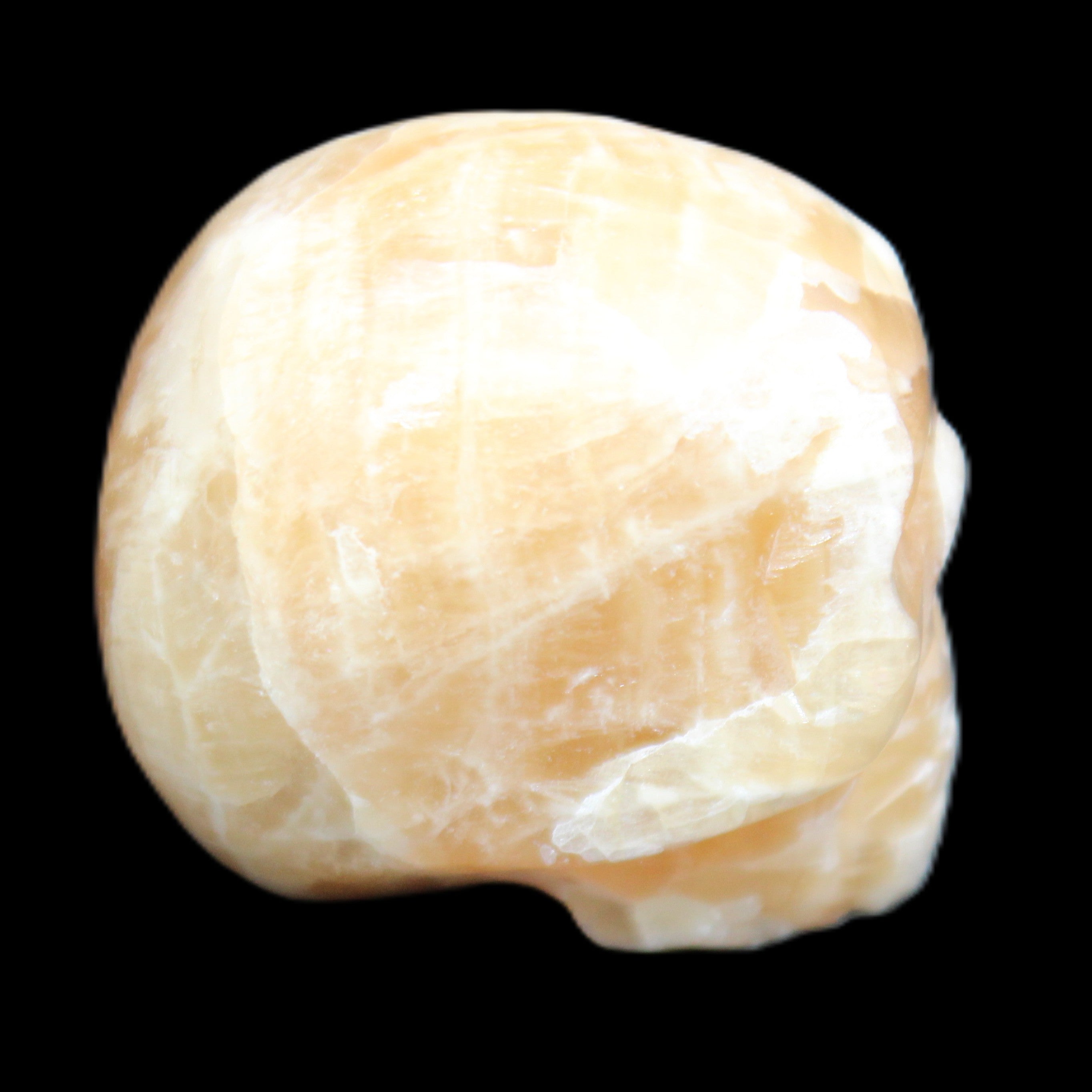 Honey Calcite skull from Pakistan 25*34*33mm 67g in sunlight - Rocks and Things Store