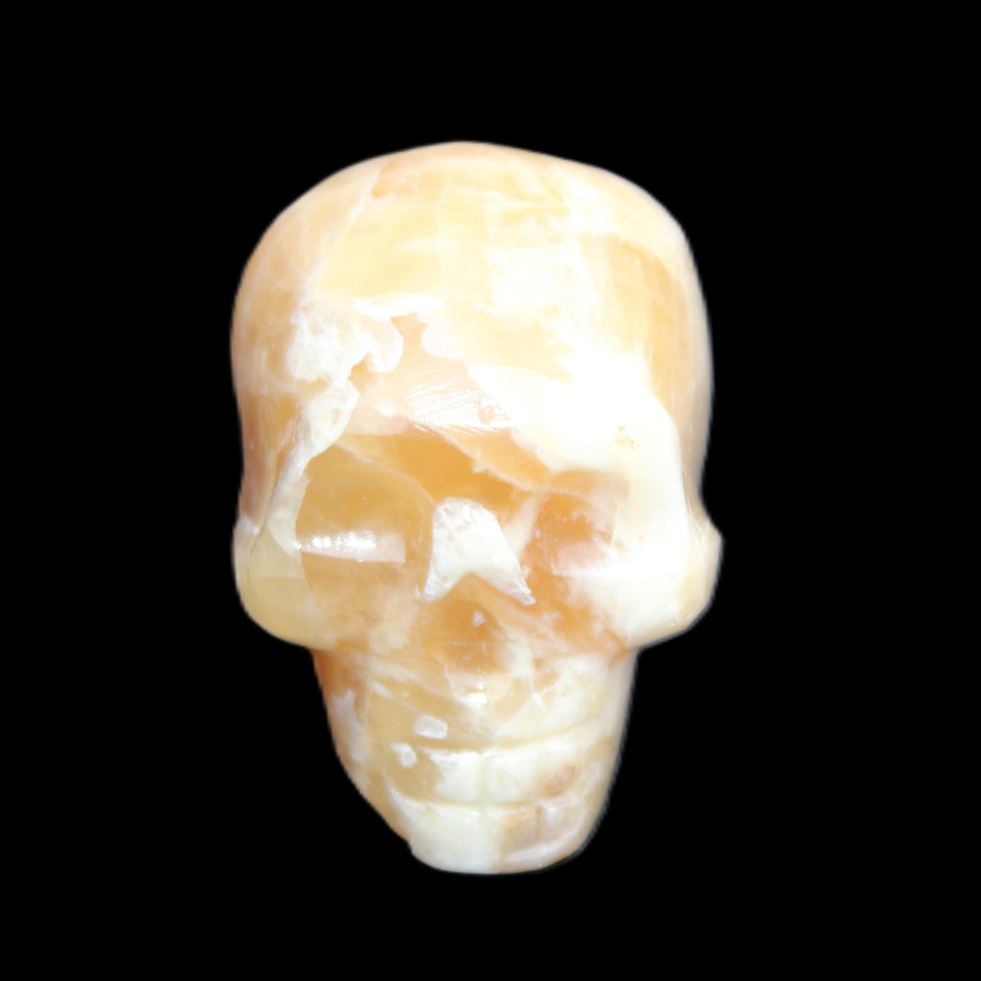 Honey Calcite skull from Pakistan 25*34*33mm 67g in sunlight - Rocks and Things Store