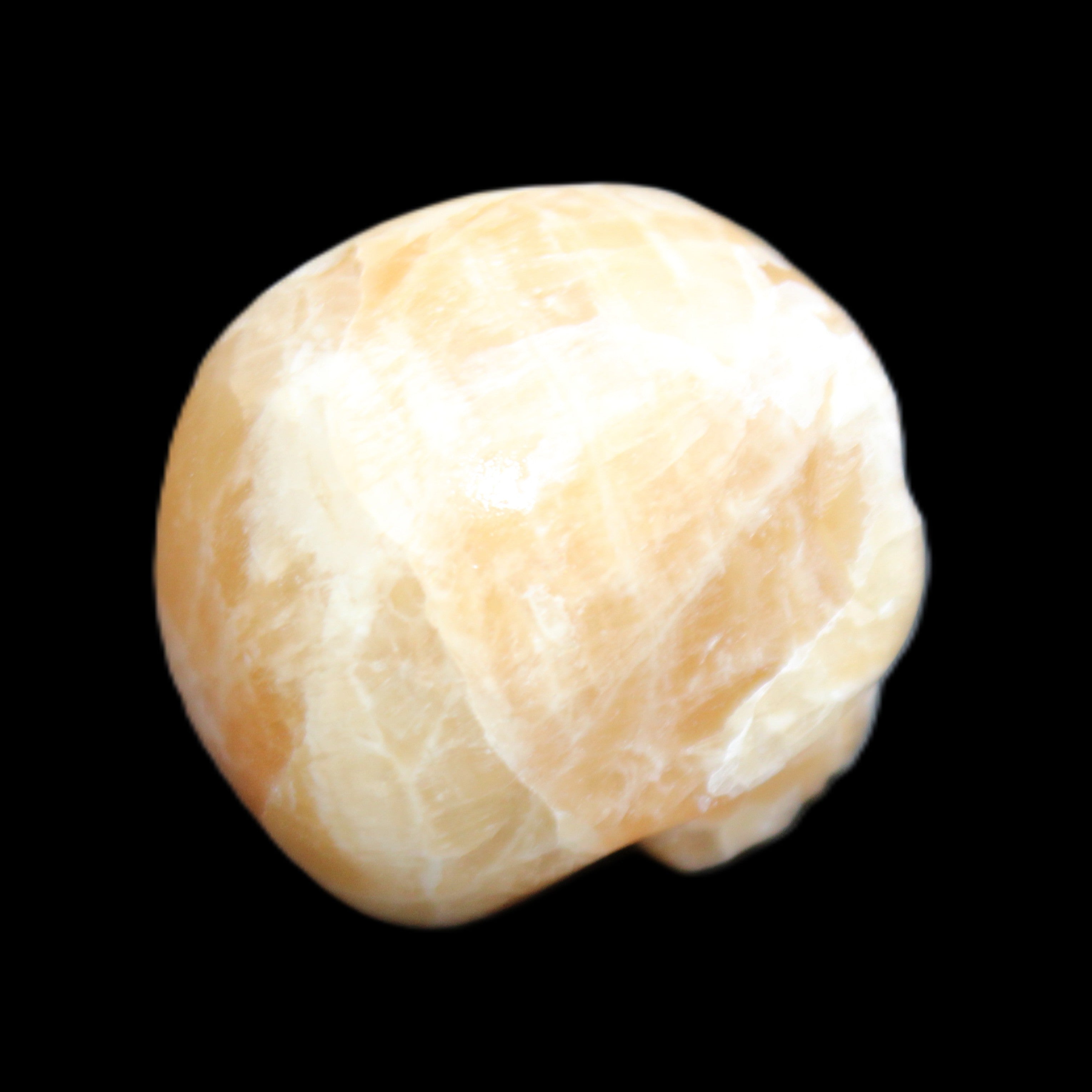 Honey Calcite skull from Pakistan 25*34*33mm 67g in sunlight - Rocks and Things Store