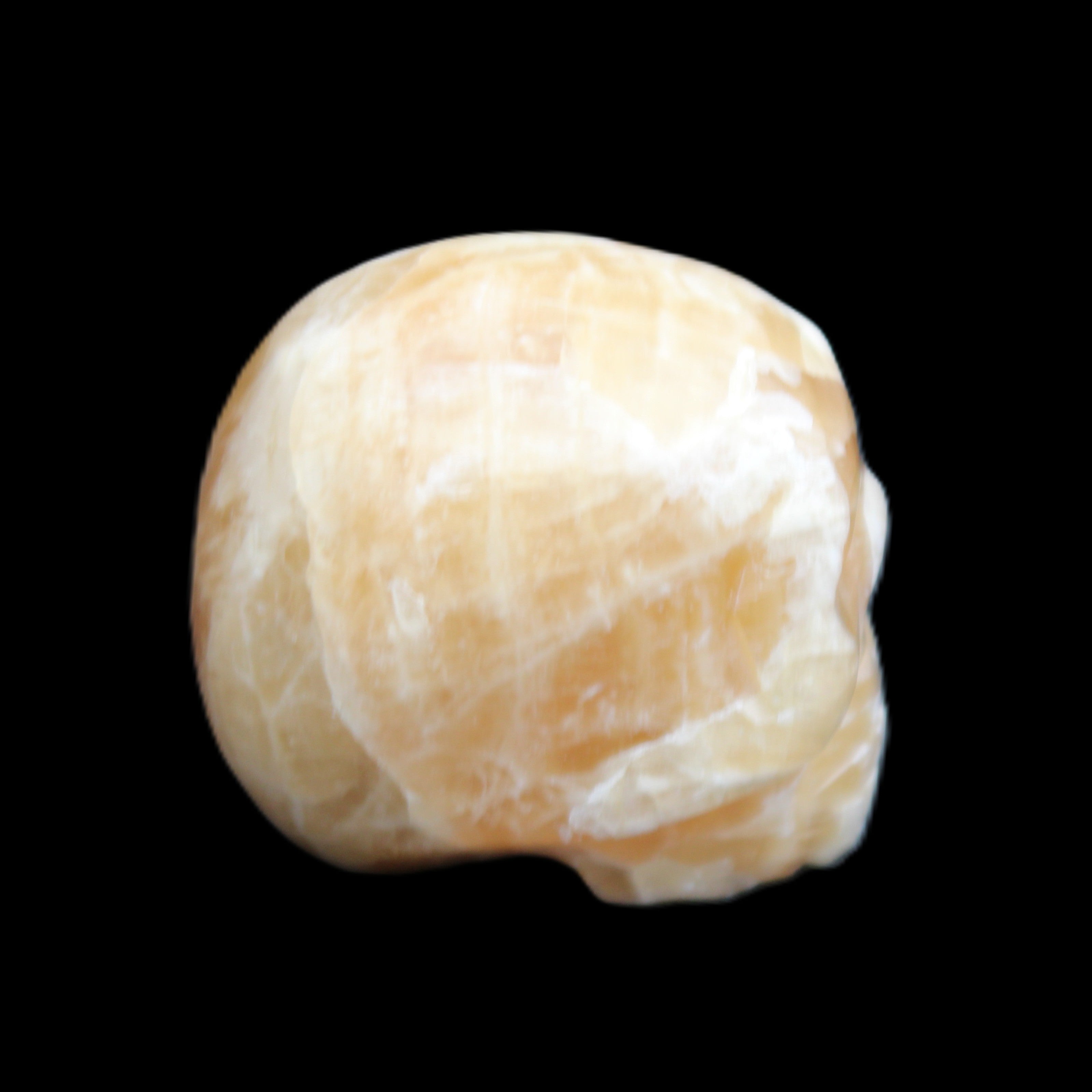 Honey Calcite skull from Pakistan 25*34*33mm 67g in sunlight - Rocks and Things Store