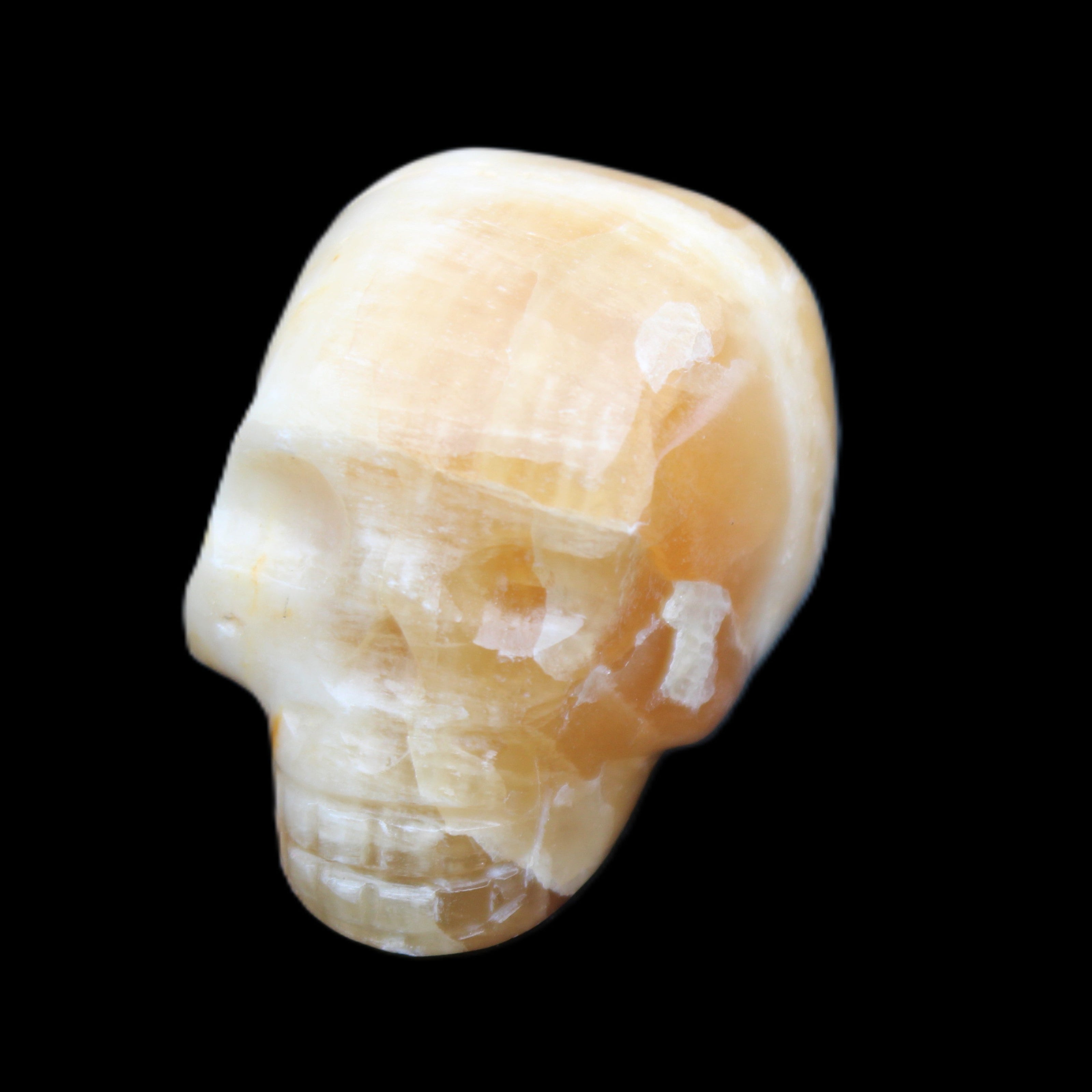 Honey Calcite skull from Pakistan 42*35*37mm 91g in sunlight - Rocks and Things Store