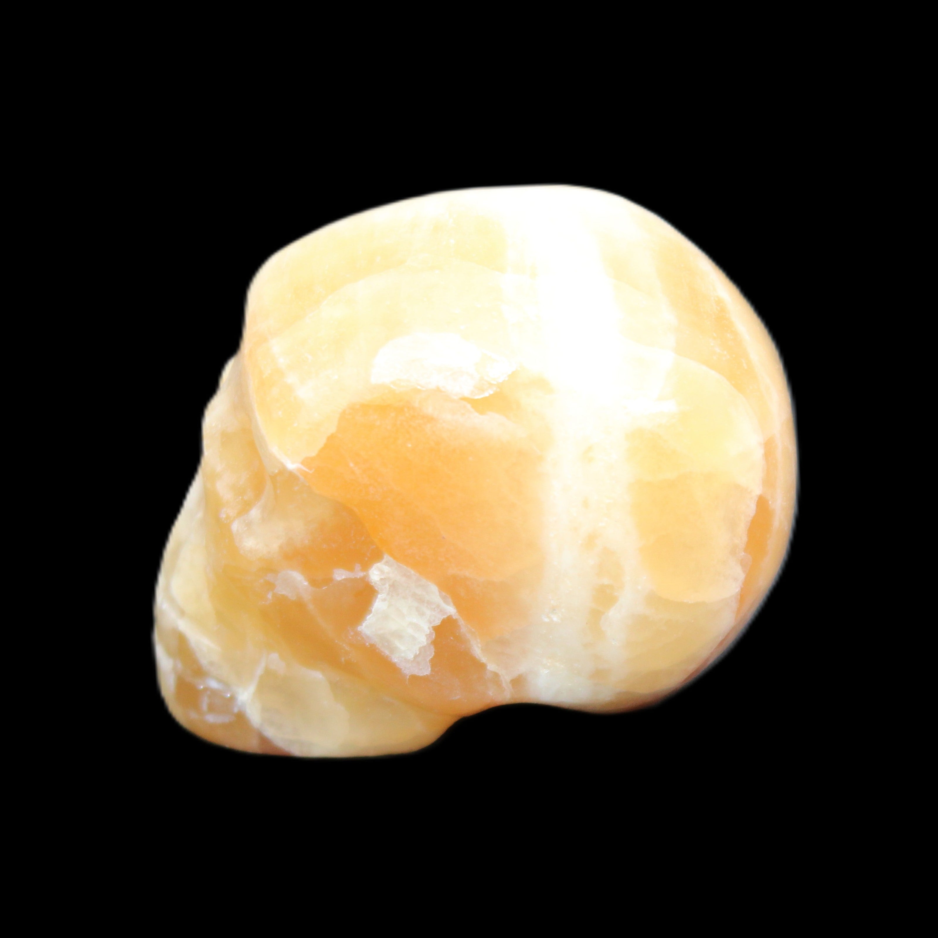 Honey Calcite skull from Pakistan 42*35*37mm 91g in sunlight - Rocks and Things Store