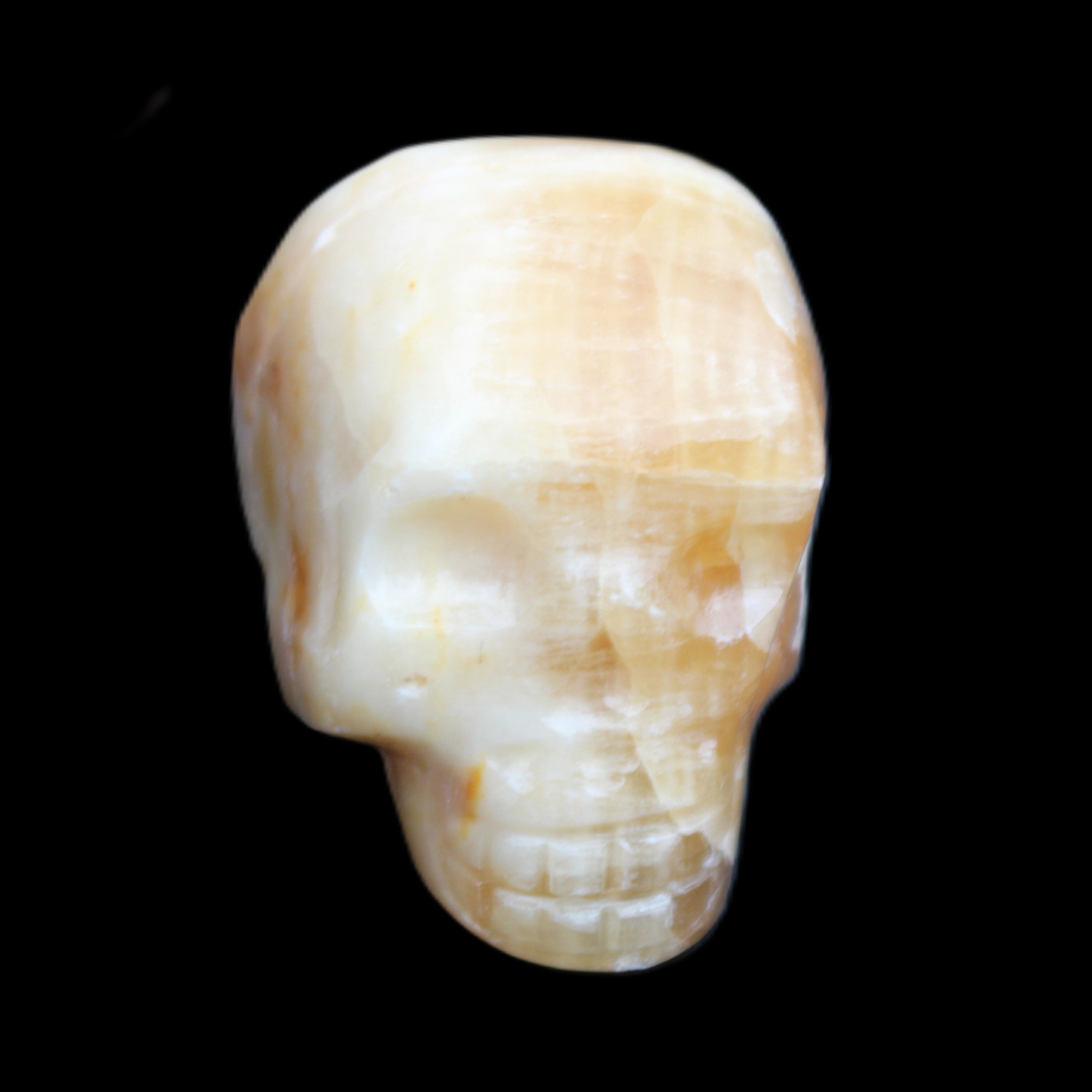 Honey Calcite skull from Pakistan 42*35*37mm 91g in sunlight - Rocks and Things Store