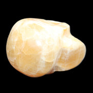 Honey Calcite skull from Pakistan 42*35*37mm 91g in sunlight - Rocks and Things Store