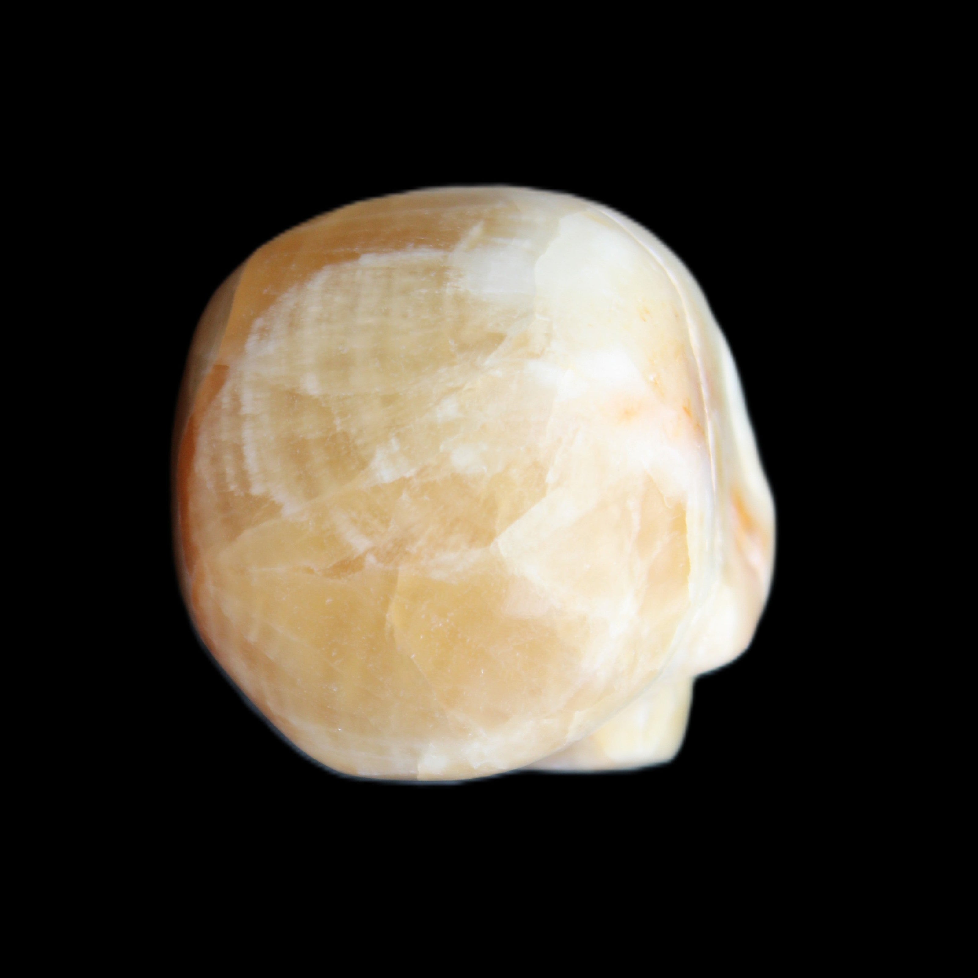 Honey Calcite skull from Pakistan 42*35*37mm 91g in sunlight - Rocks and Things Store