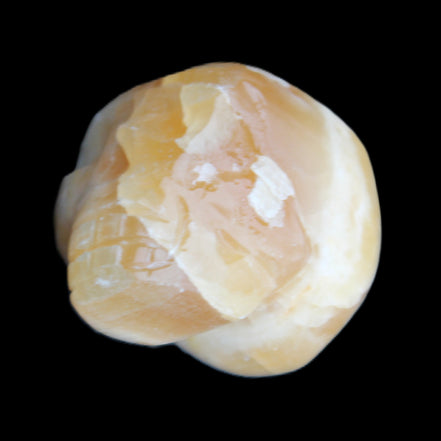 Honey Calcite skull from Pakistan 42*35*37mm 91g in sunlight - Rocks and Things Store