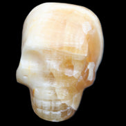 Honey Calcite skull from Pakistan 42*35*37mm 91g in sunlight - Rocks and Things Store