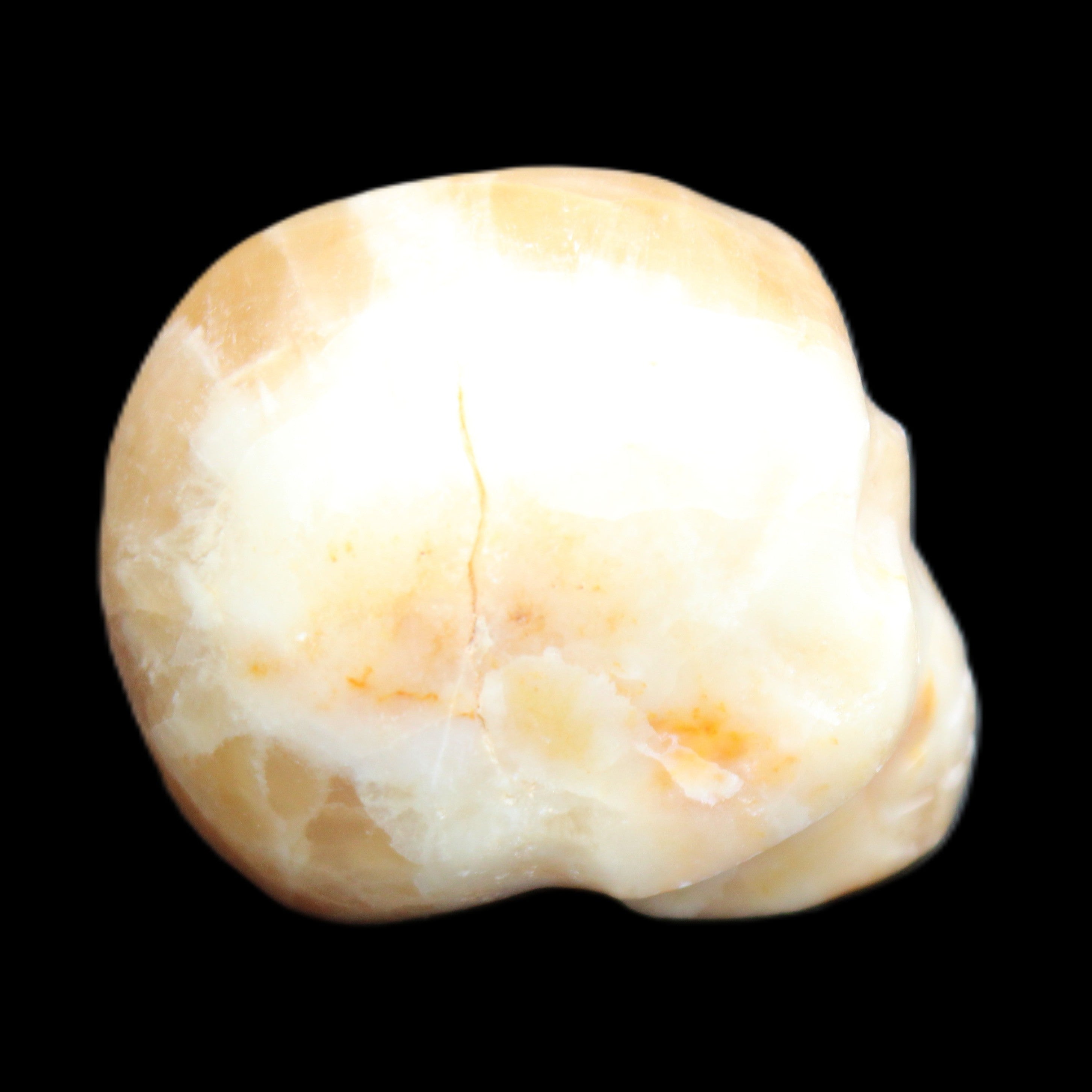 Honey Calcite skull from Pakistan 42*35*37mm 91g in sunlight - Rocks and Things Store