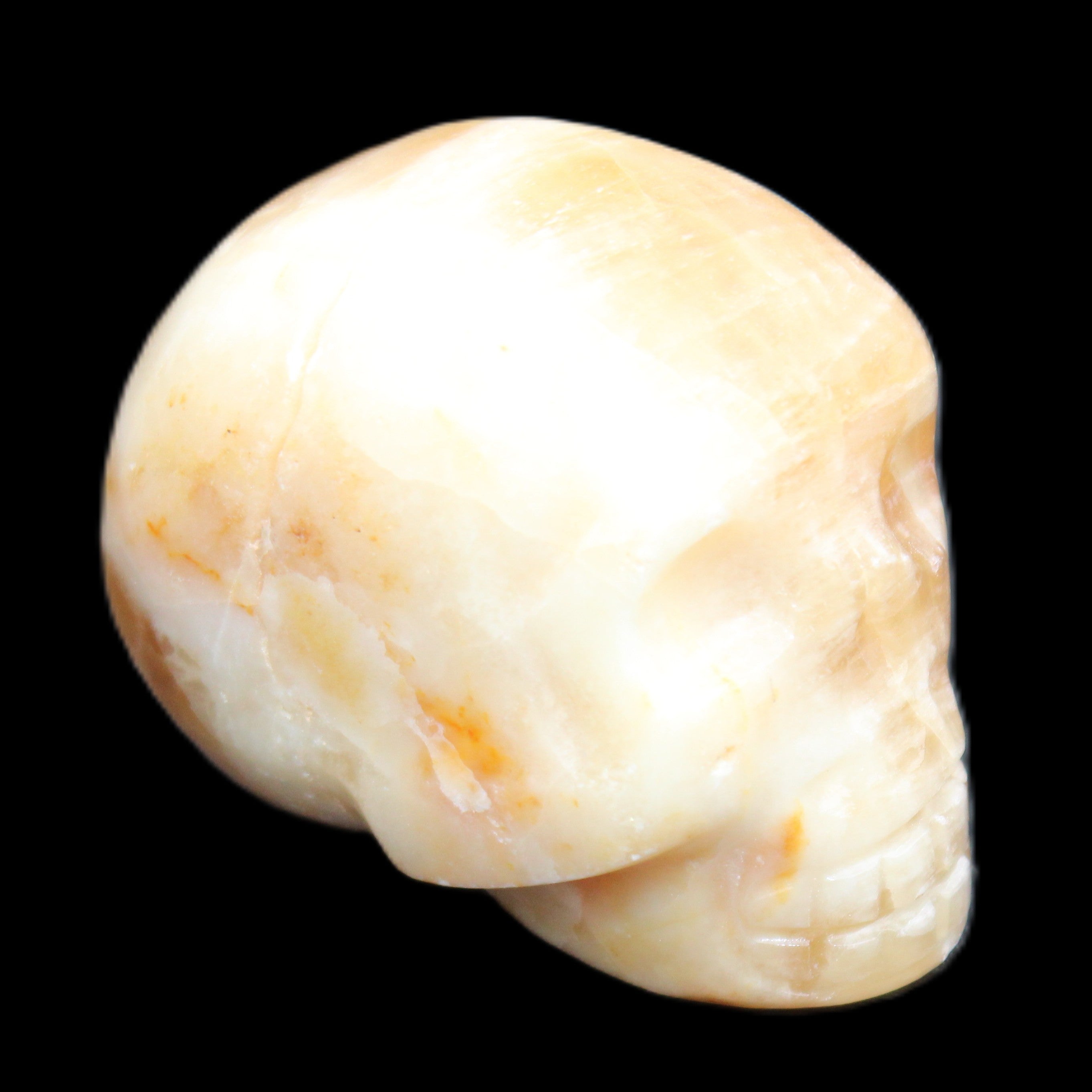 Honey Calcite skull from Pakistan 42*35*37mm 91g in sunlight - Rocks and Things Store