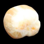 Honey Calcite skull from Pakistan 42*35*37mm 91g in sunlight - Rocks and Things Store