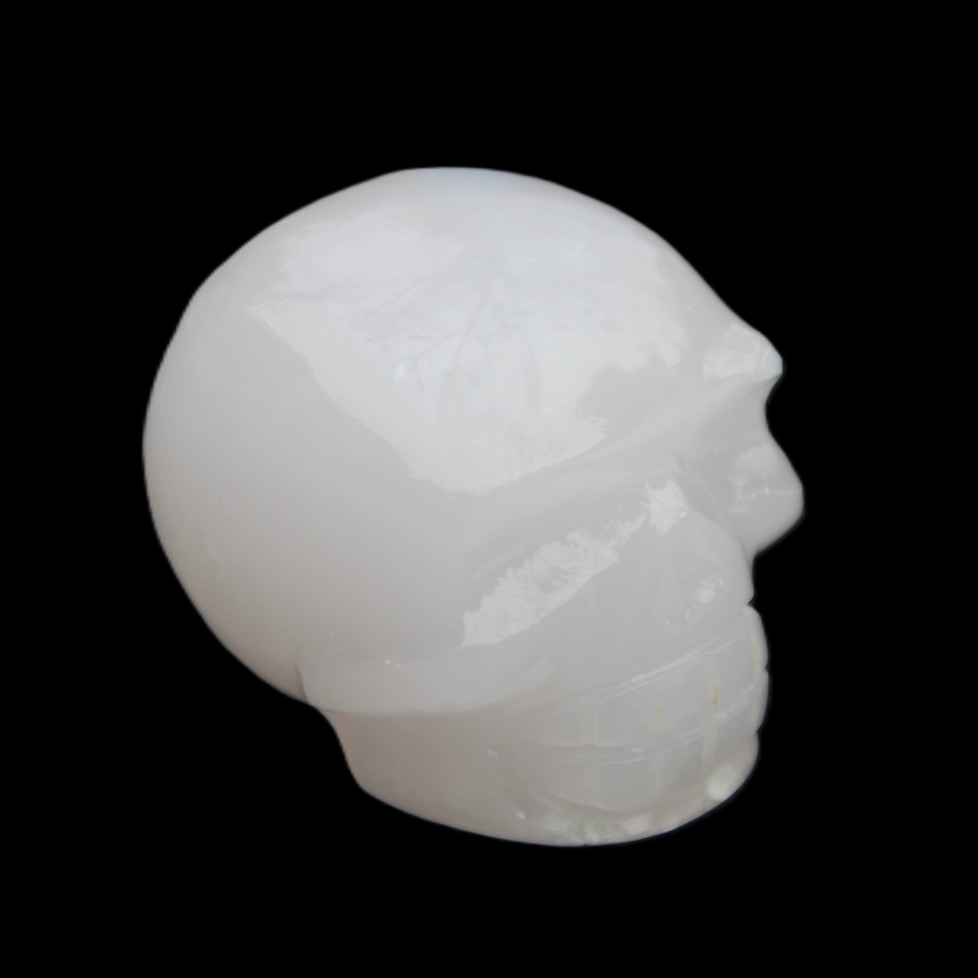 Mangano Calcite skull 45*52*48mm 196g in sunlight - Rocks and Things Store