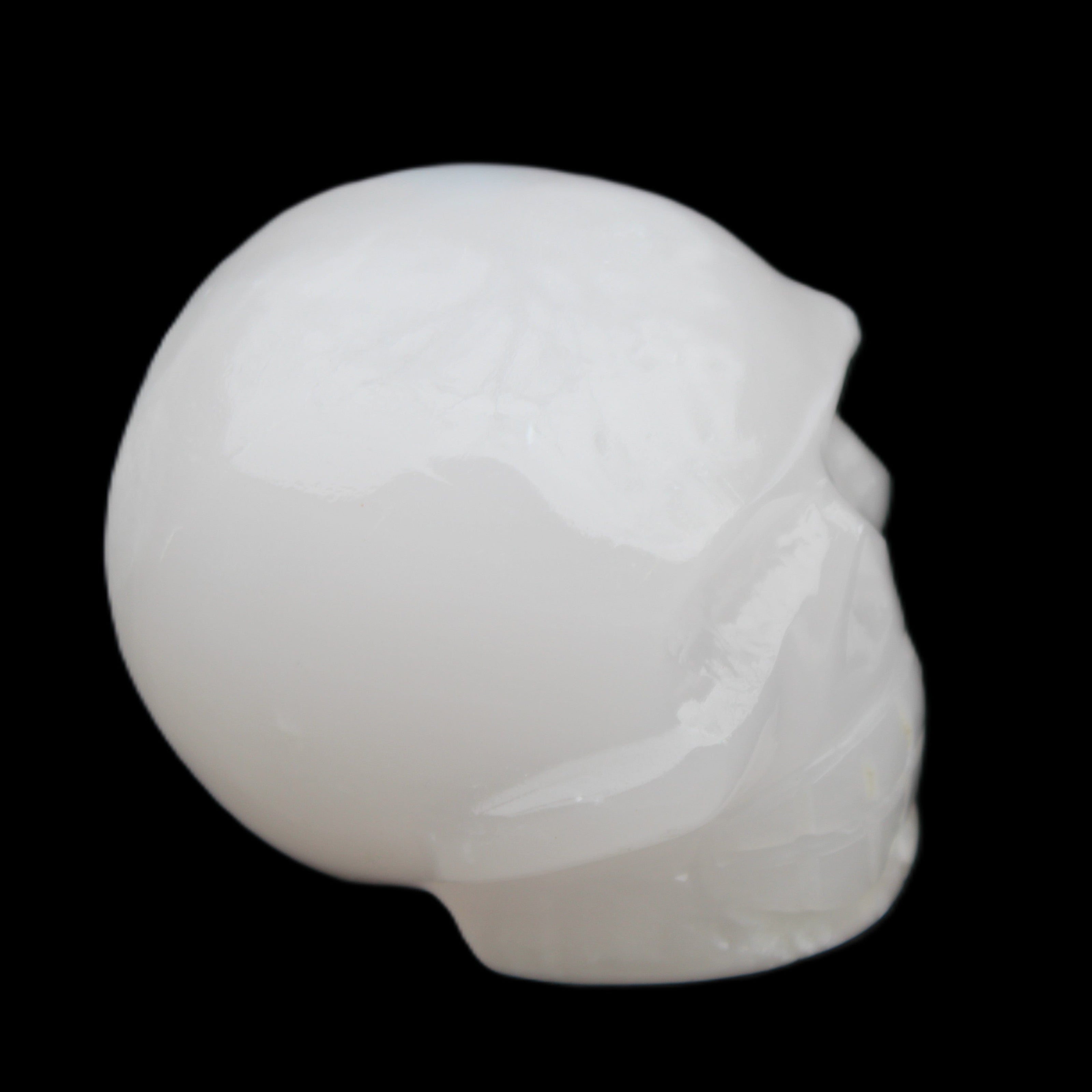 Mangano Calcite skull 45*52*48mm 196g in sunlight - Rocks and Things Store