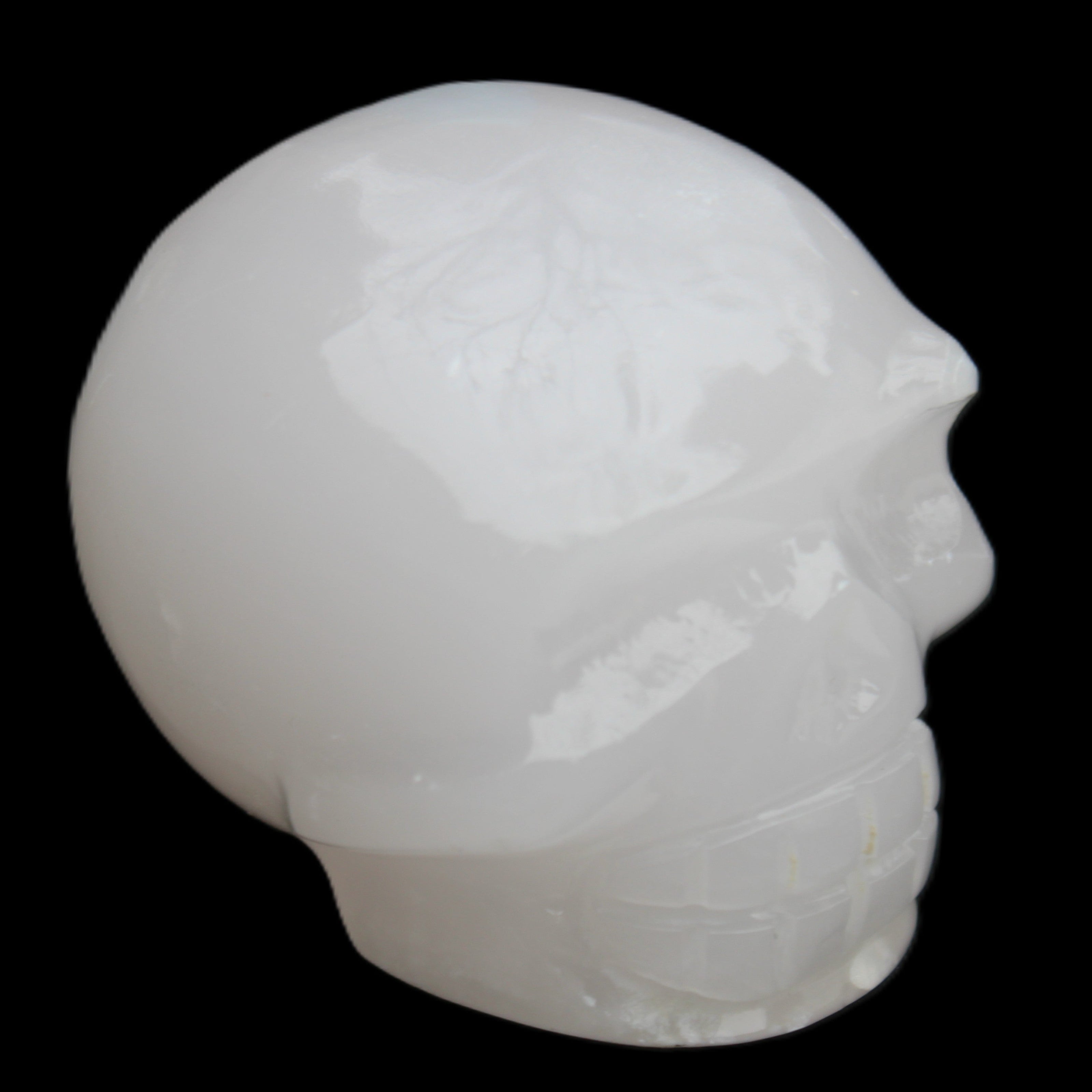 Mangano Calcite skull 45*52*48mm 196g in sunlight - Rocks and Things Store