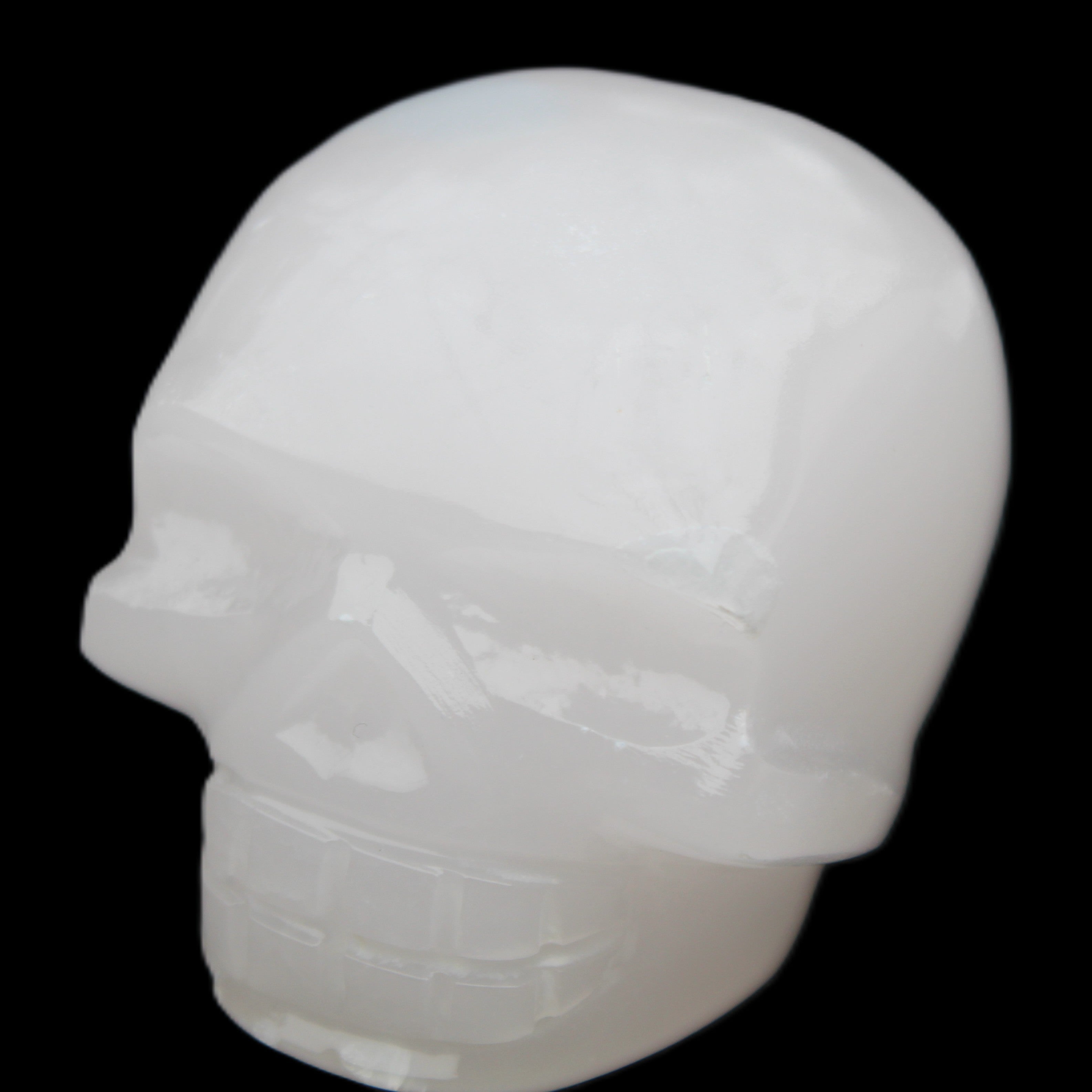 Mangano Calcite skull 45*52*48mm 196g in sunlight - Rocks and Things Store