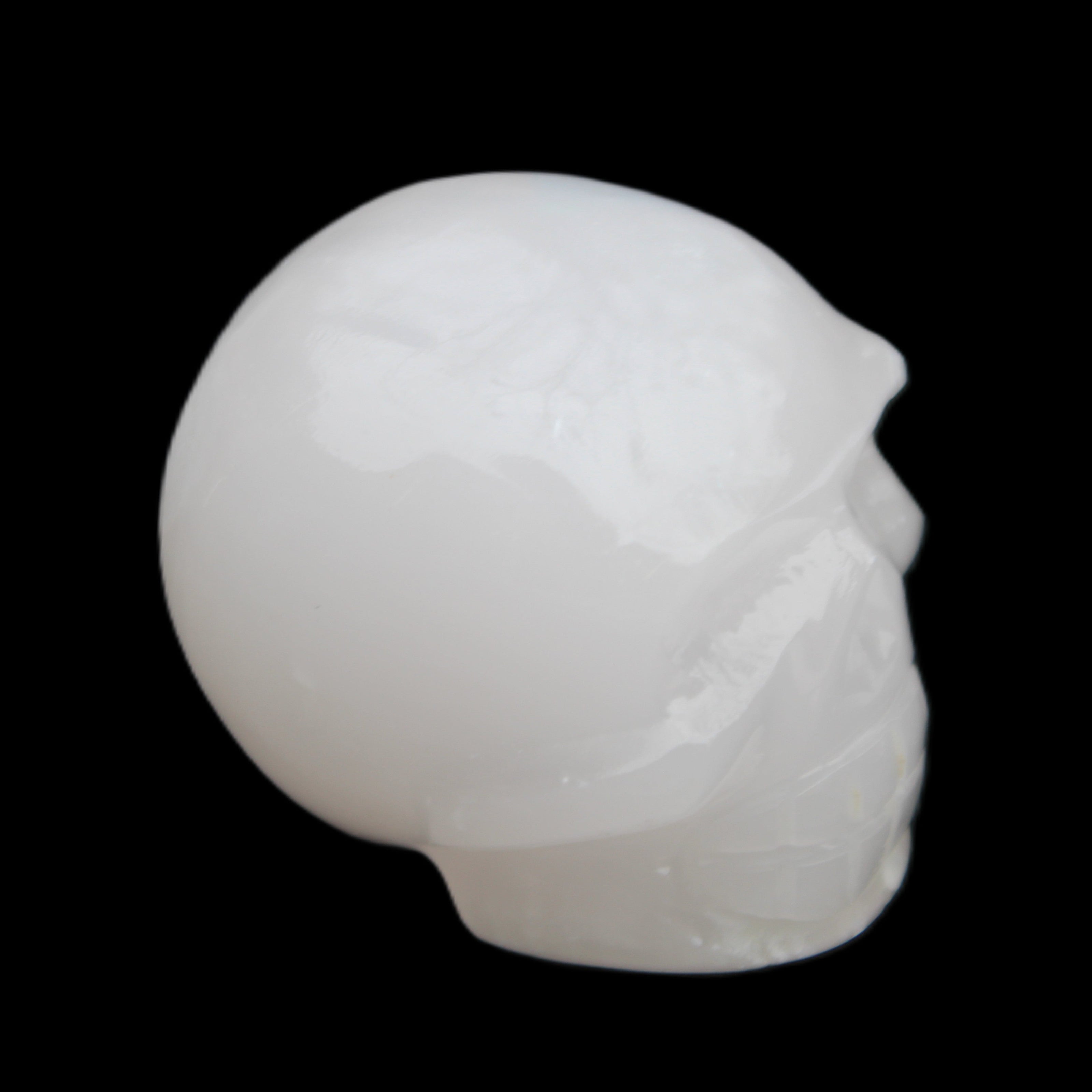 Mangano Calcite skull 45*52*48mm 196g in sunlight - Rocks and Things Store