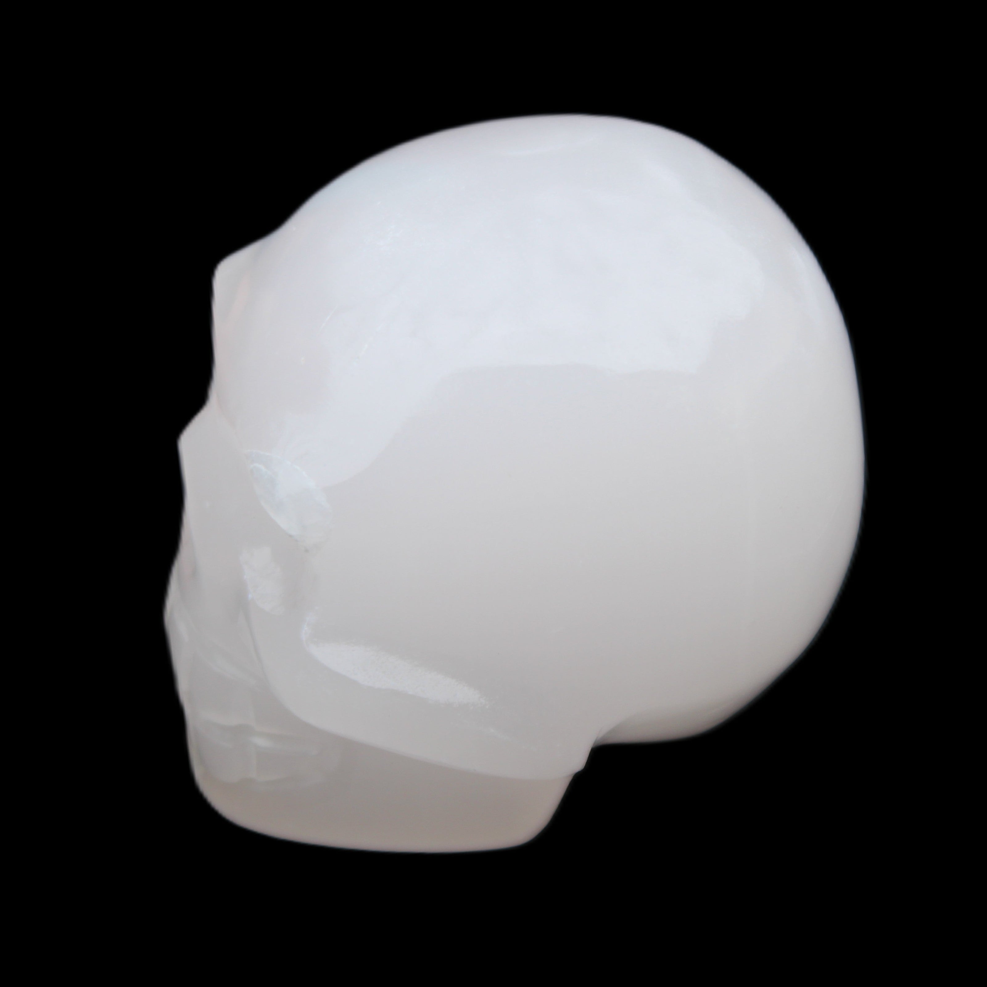 Mangano Calcite skull 45*52*48mm 196g in sunlight - Rocks and Things Store